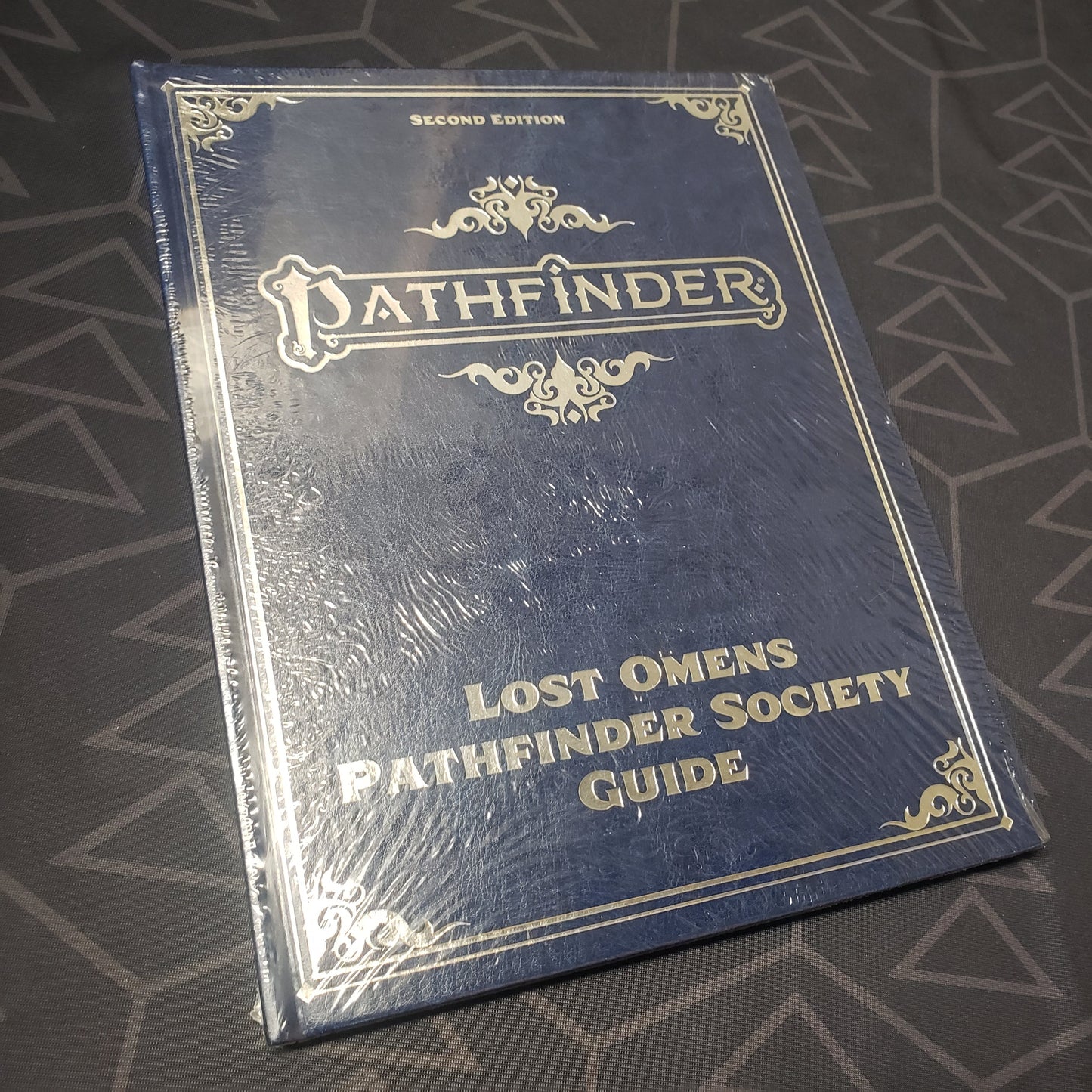 Image shows the front cover of the Lost Omens: Pathfinder Society Guide (Special Edition) book for the roleplaying game Pathfinder 2E