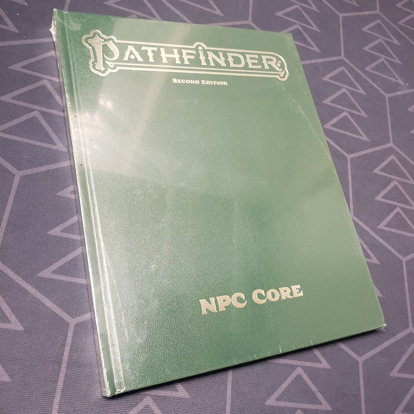 Image shows the front cover of the special edition of the NPC Core book for the roleplaying game Pathfinder 2E