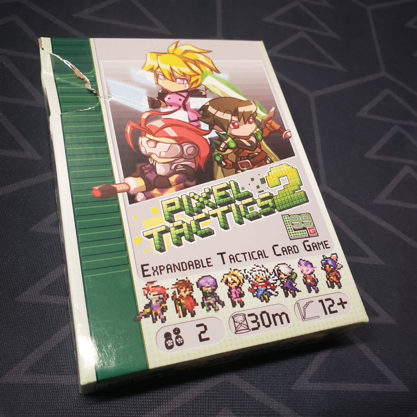 Image shows the front cover of the box for the Pixel Tactics 2 card game