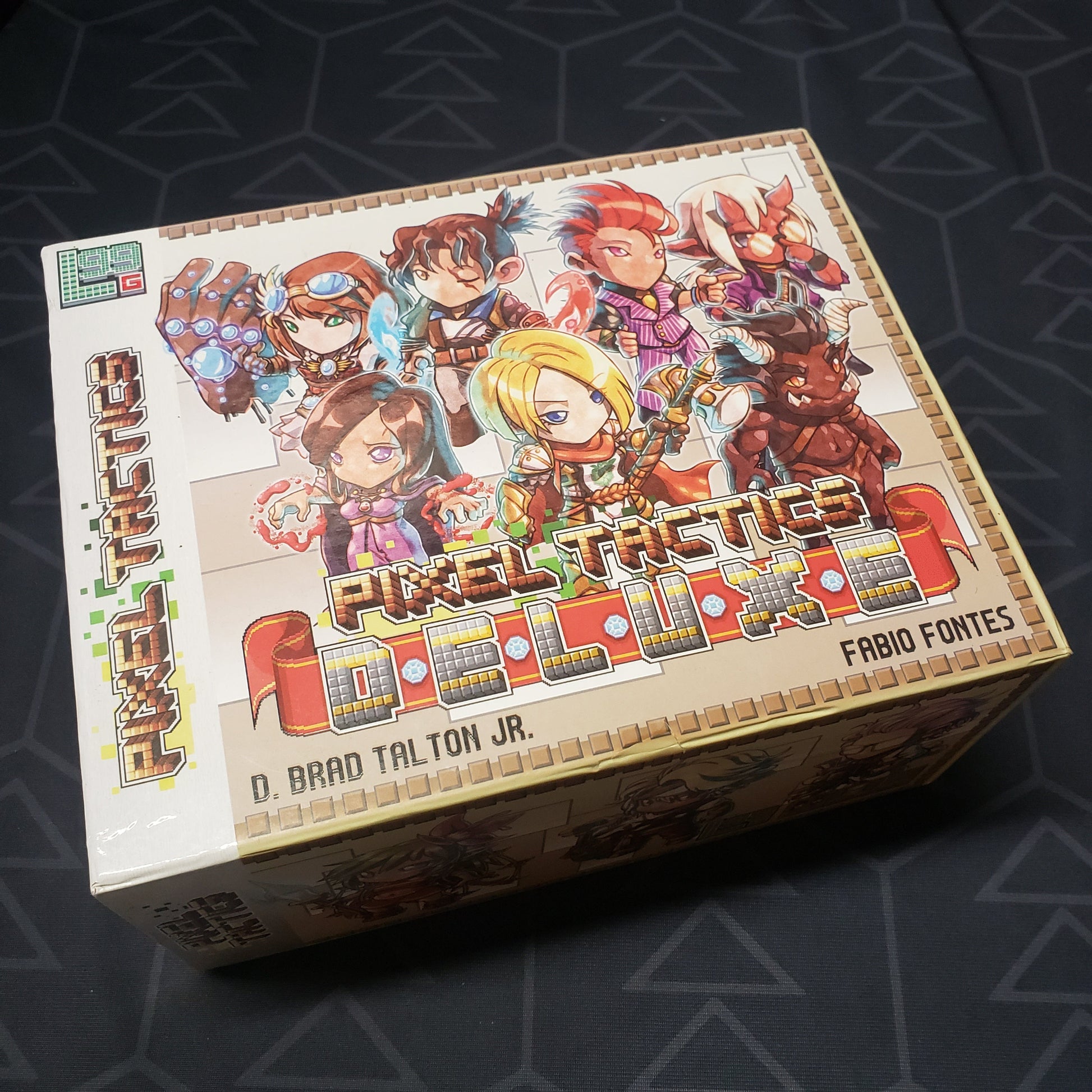 Image shows the front cover of the box for the Pixel Tactics Deluxe card game