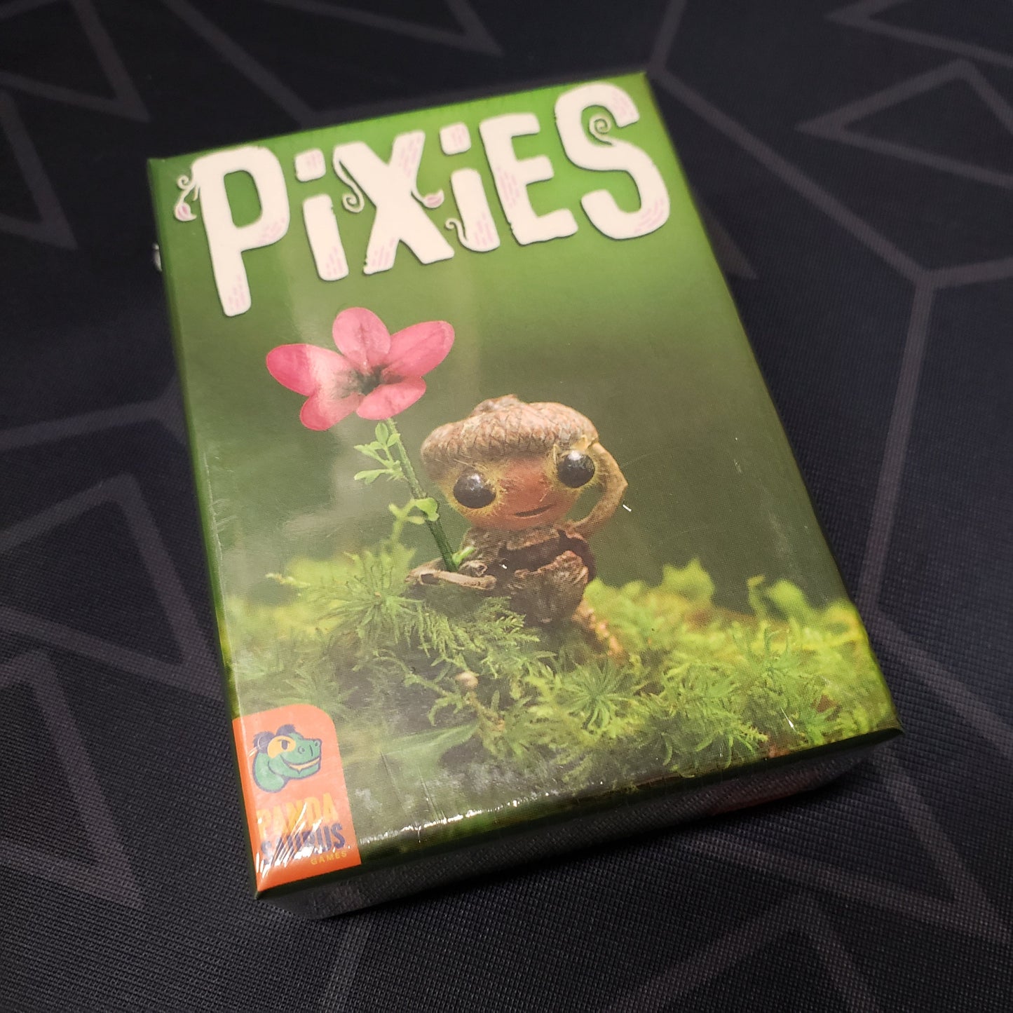 Image shows the front cover of the box of the Pixies card game