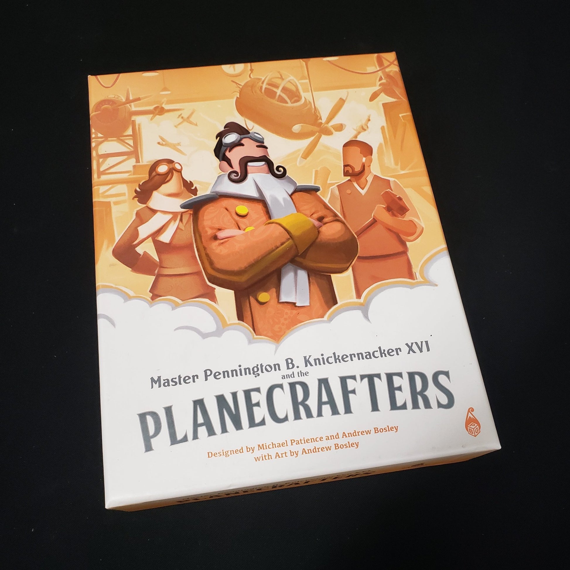 Image shows the front cover of the box of the Planecrafters board game