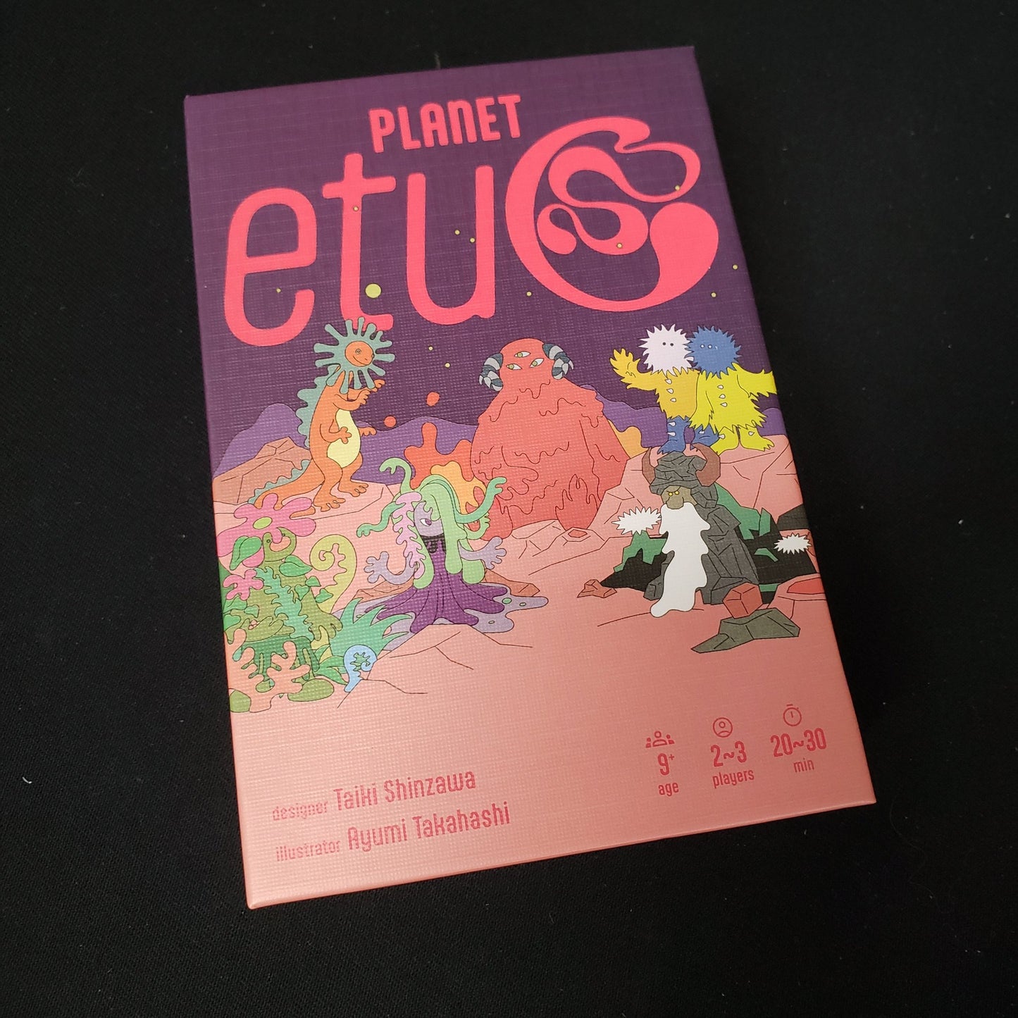 Image shows the front cover of the box of the card game Planet etuC