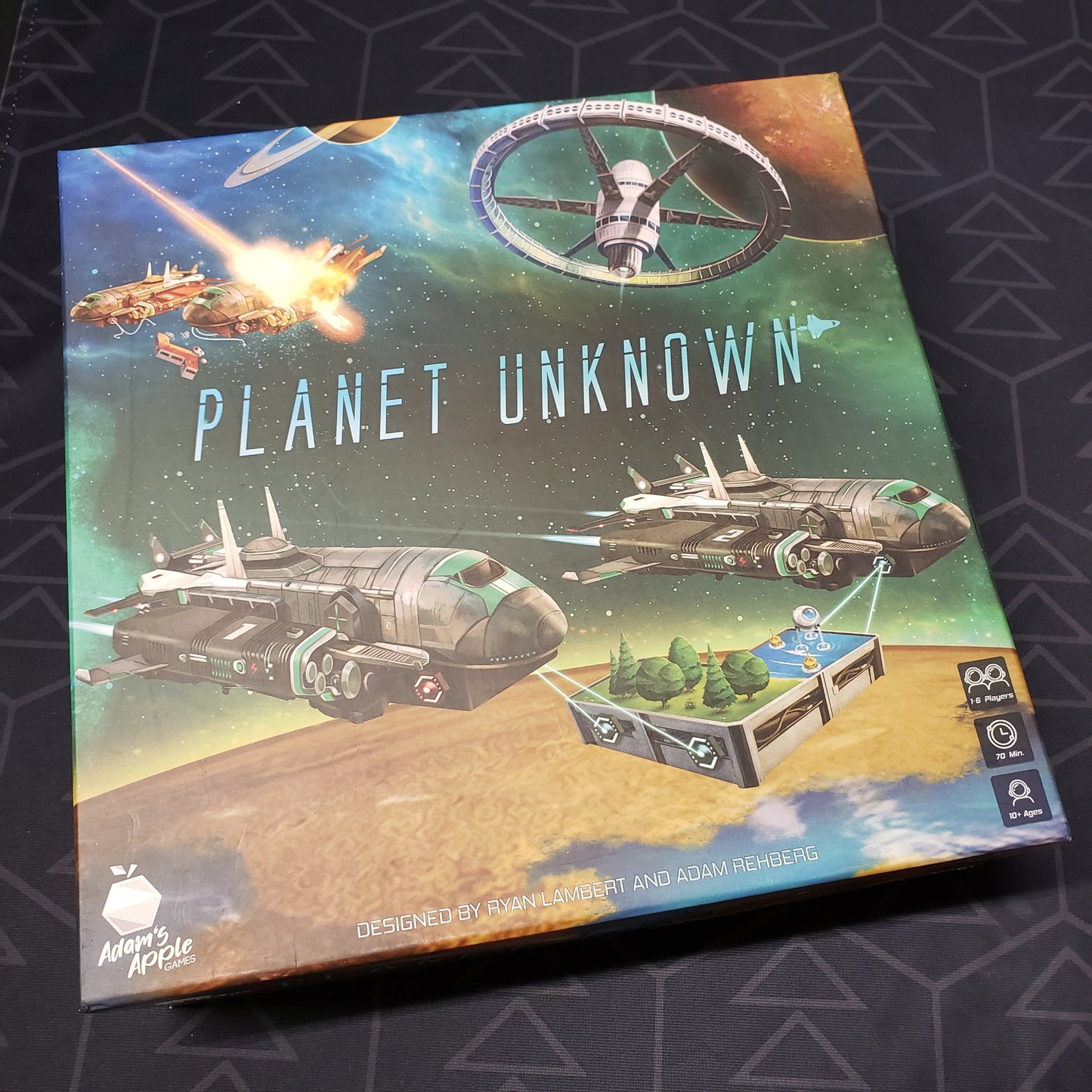 Image shows the front cover of the box for the Planet Unknown board game