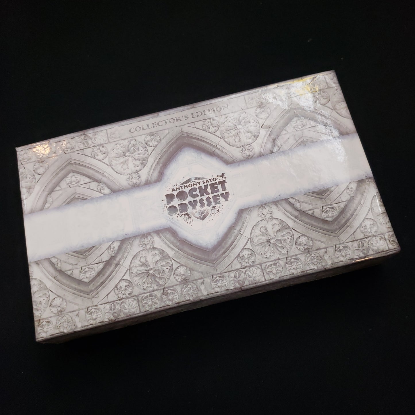 Image shows the front cover of the box of the Pocket Odyssey: Collector's Edition board game