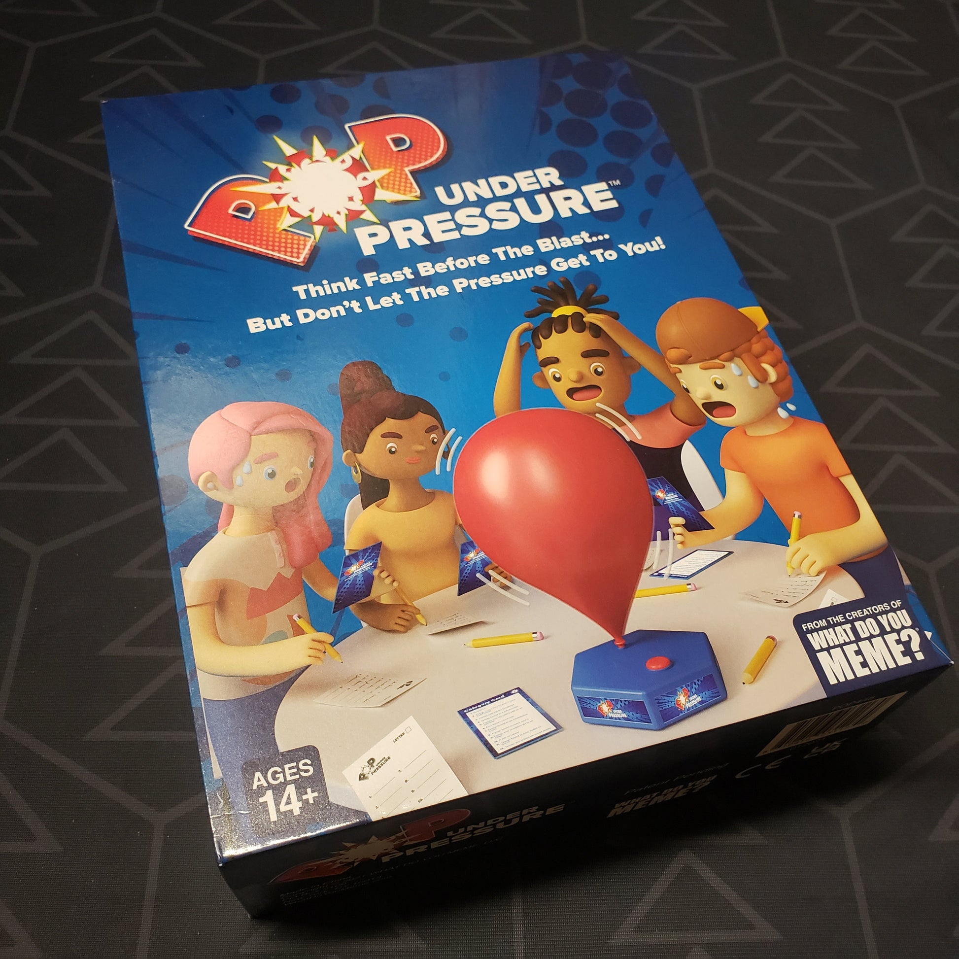 Image shows the front cover of the box for the Pop Under Pressure board game