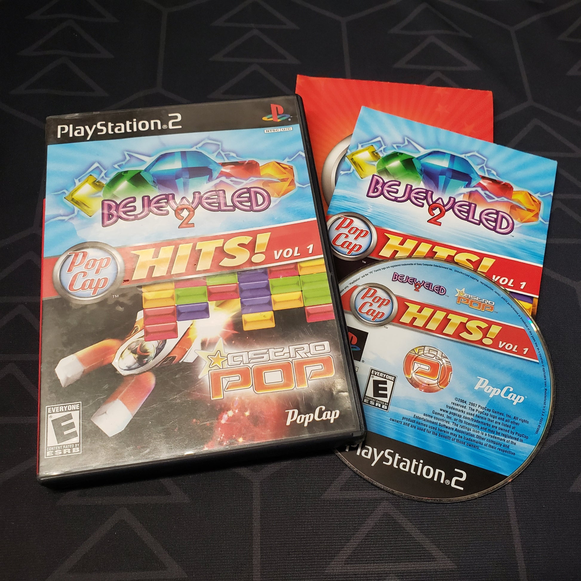 Image shows the case, manual and disc for the video game PopCap Hits!: Vol. 1 for Playstation 2