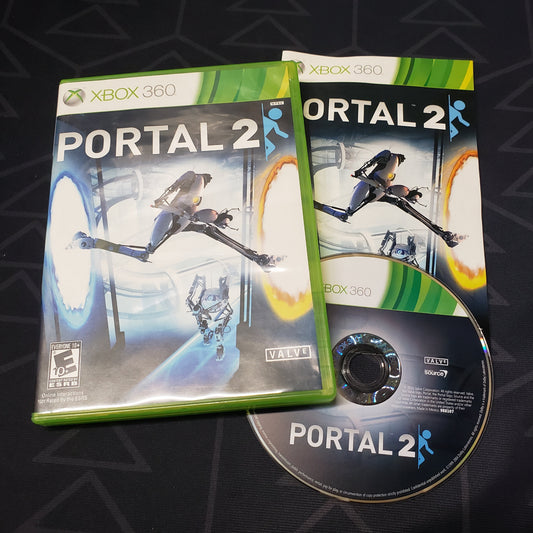 Image shows the case, manual and disc for the video game Portal 2 for Xbox 360