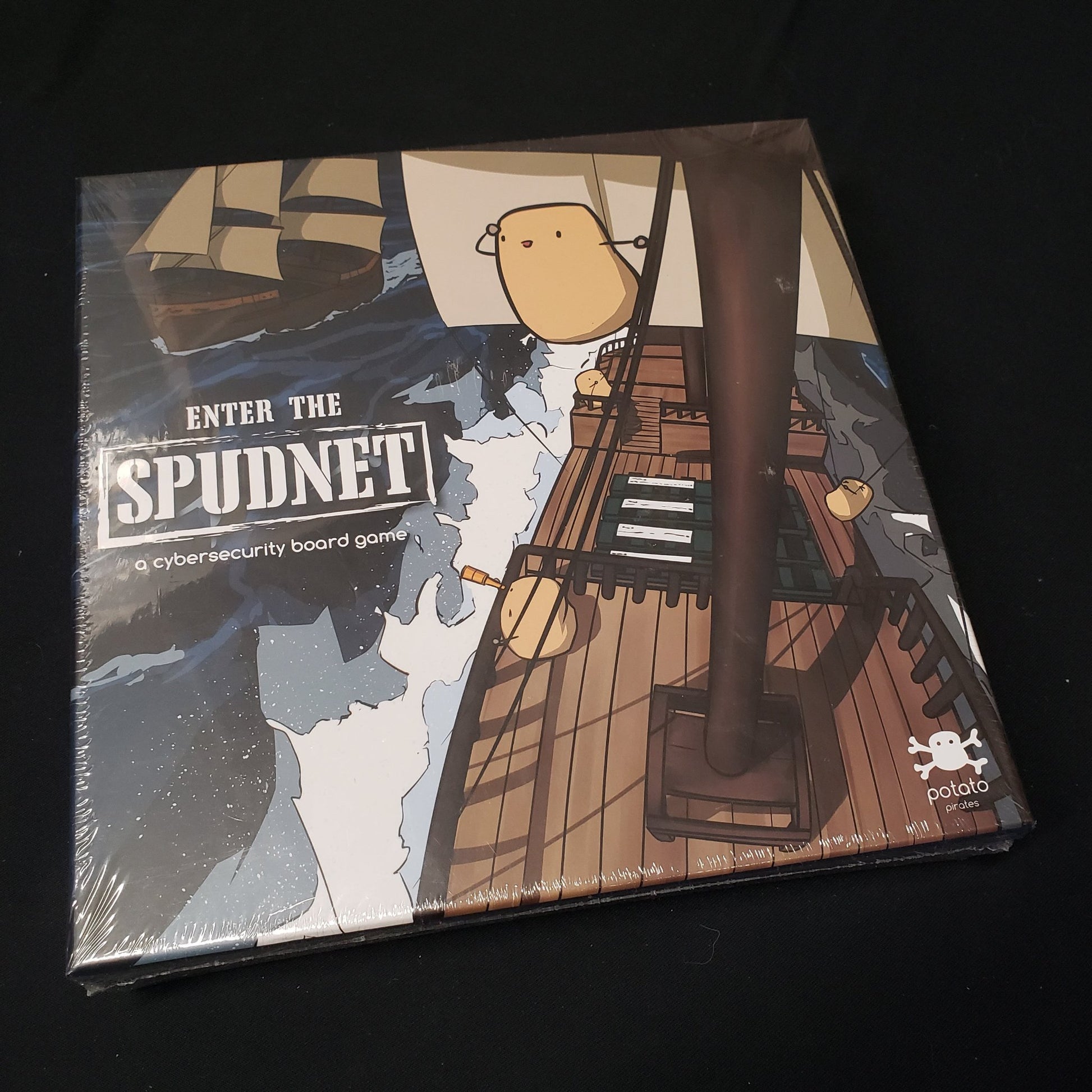 Image shows the front cover of the box of the Potato Pirates: Enter the Spudnet card game