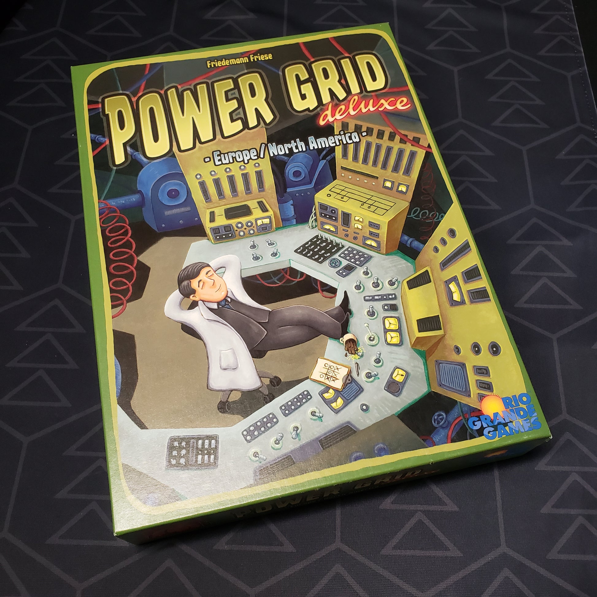 Image shows the front cover of the box for the Power Grid: Deluxe Edition board game