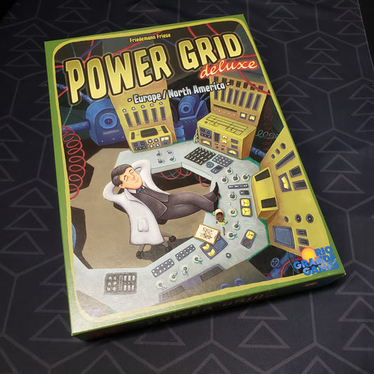 Image shows the front cover of the box for the Power Grid: Deluxe Edition board game