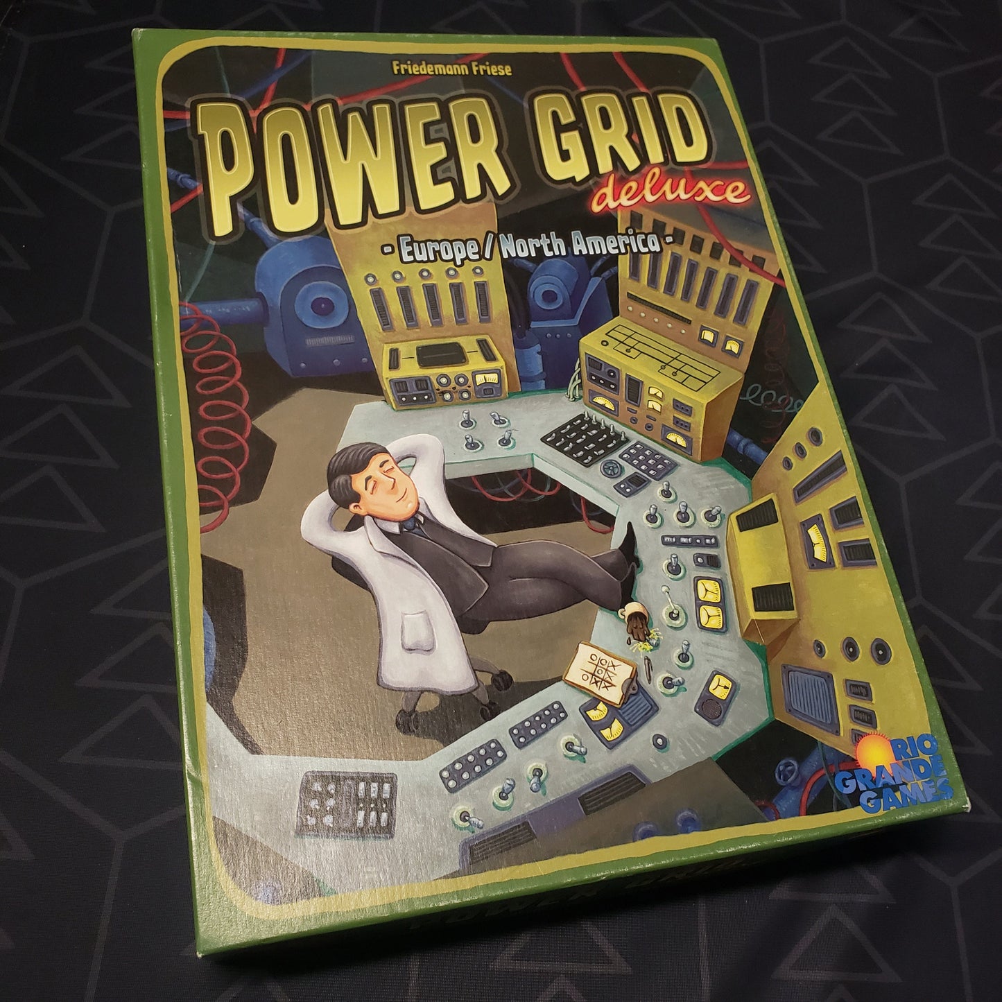 Image shows the front cover of the box for the Power Grid: Deluxe Edition board game