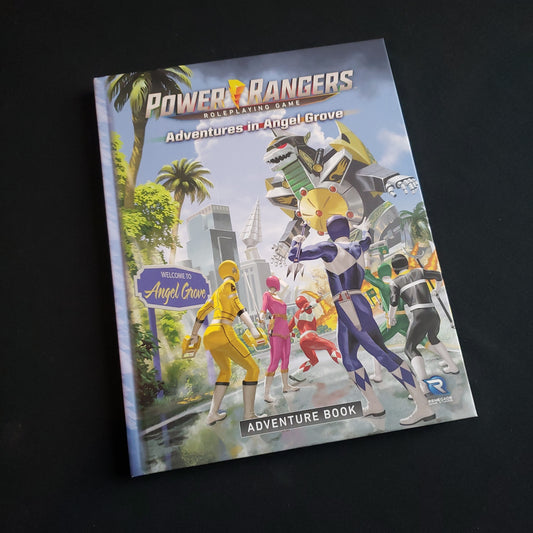 Image shows the front cover of the Adventures in Angel Grove book for the Power Rangers roleplaying game