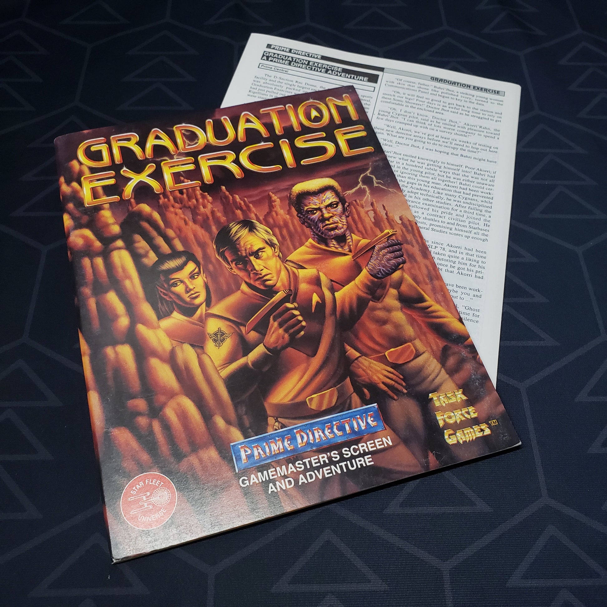 Image shows the front cover of the Graduation Exercise (GM Screen & Adventure) book for the roleplaying game Prime Directive