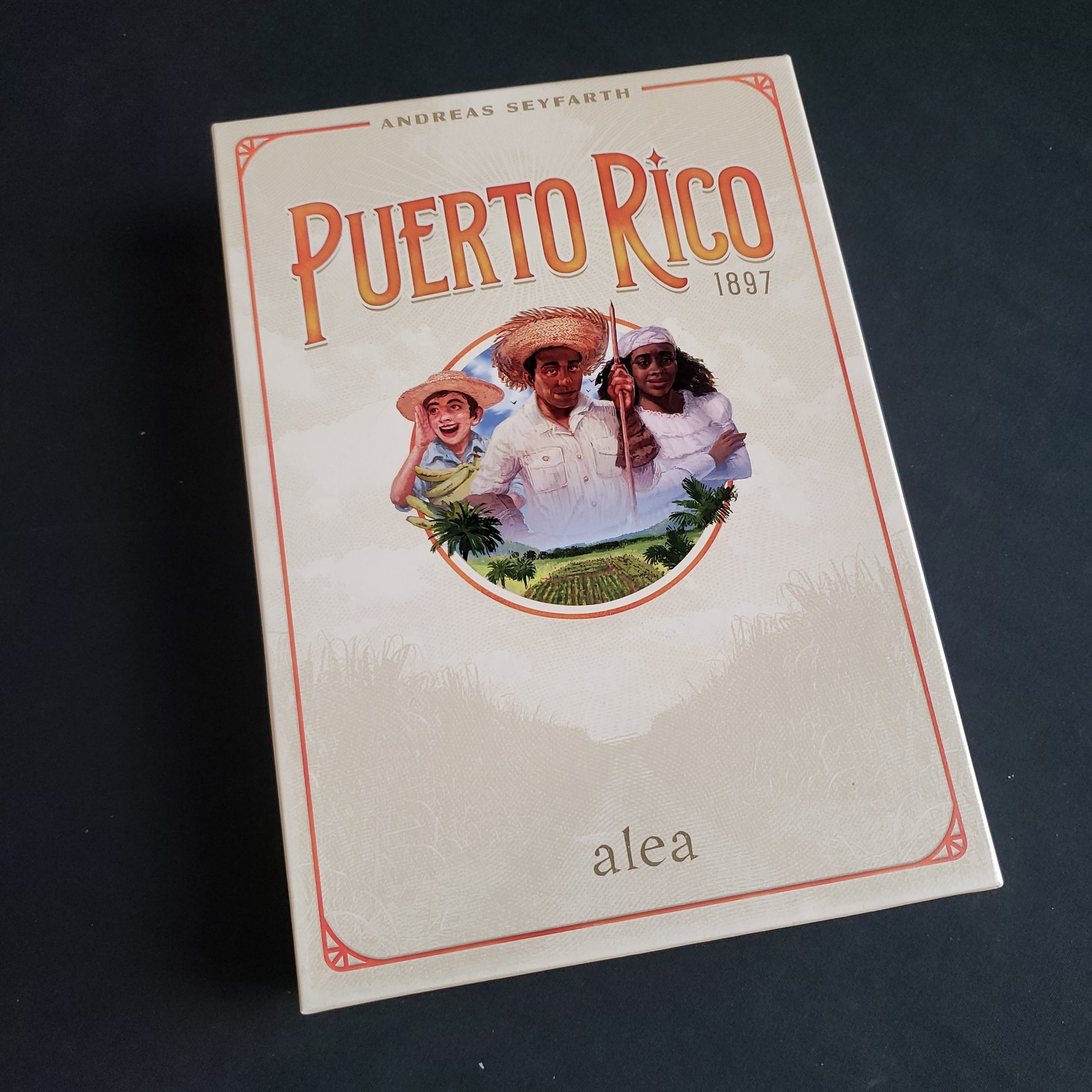 Image shows the front cover of the box of the Puerto Rico 1897 board game