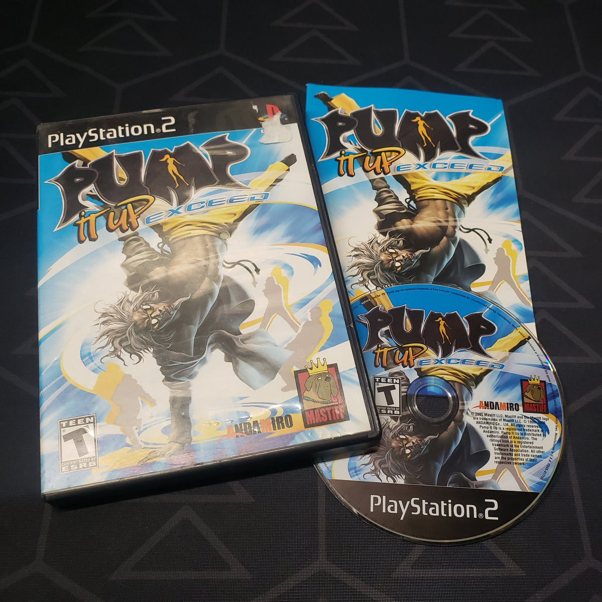 Image shows the case, manual and disc for the video game Pump It Up: Exceed for Playstation 2