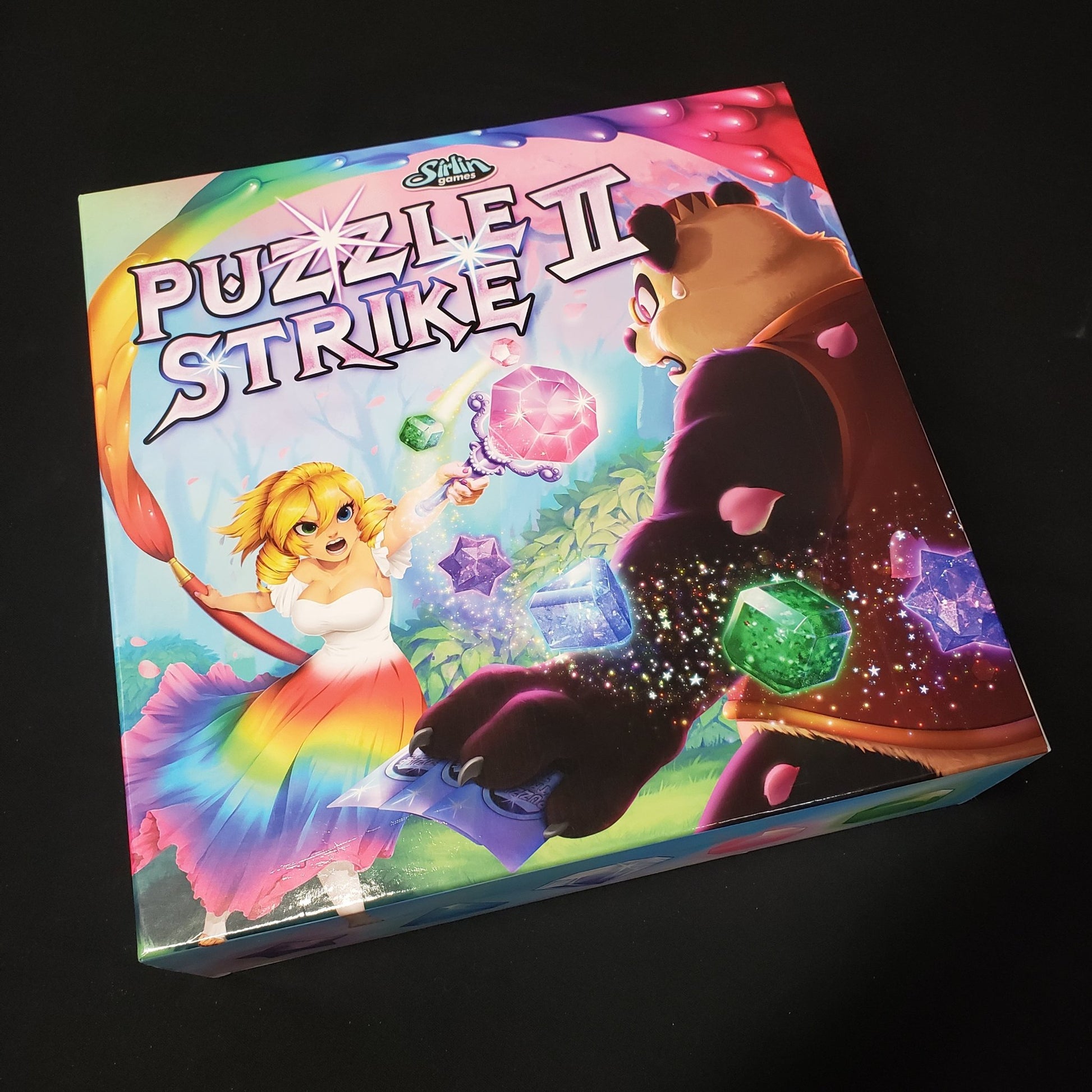 Image shows the front cover of the box of the Puzzle Strike II board game