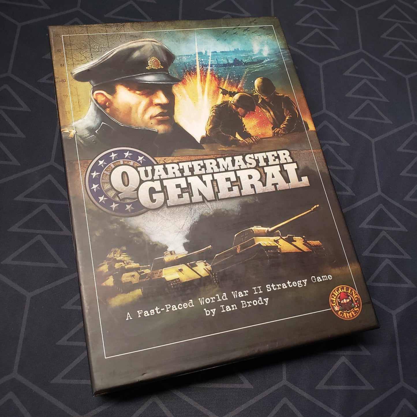 Image shows the front cover of the box of the Quartermaster General board game