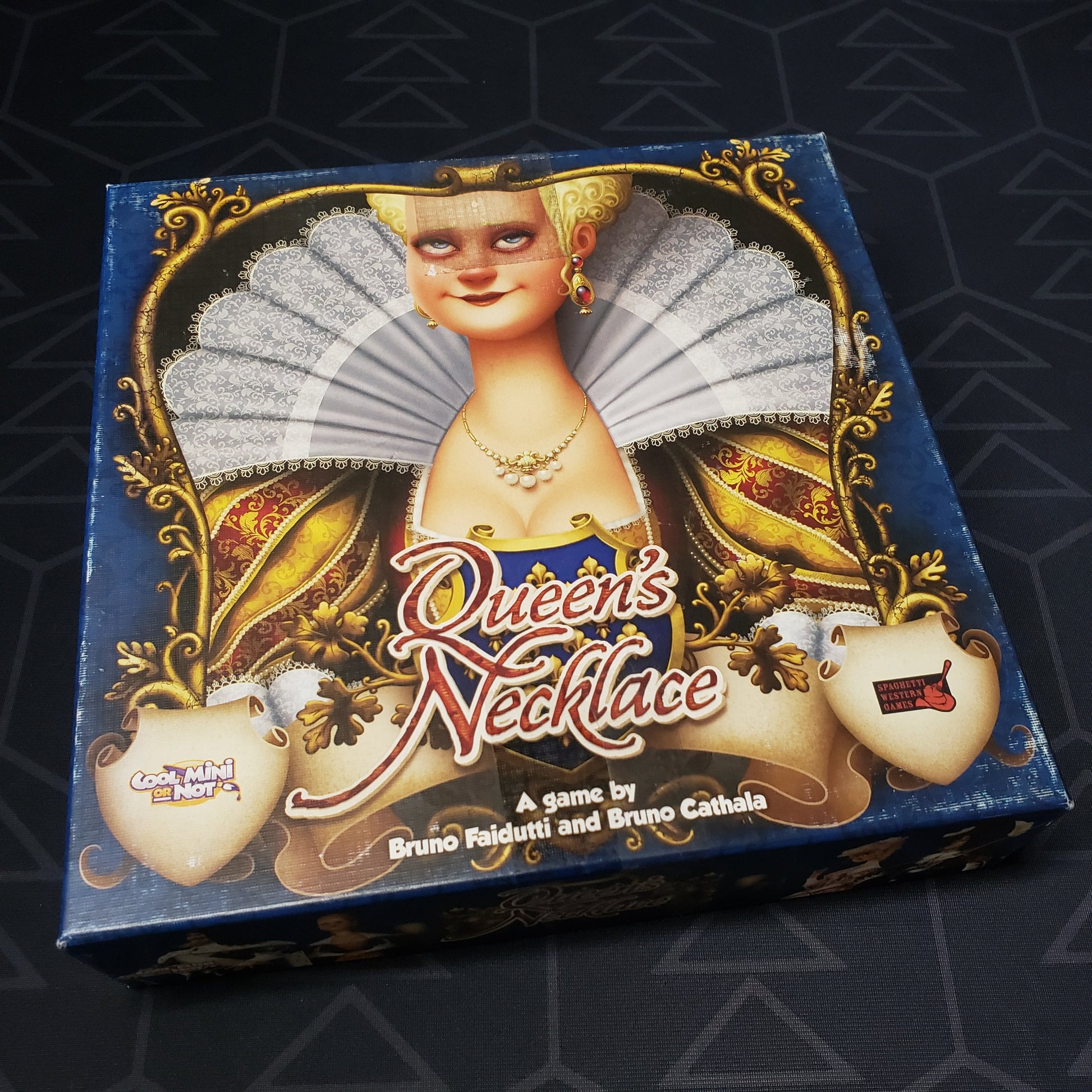 Image shows the front cover of the box of the Queen's Necklace card game