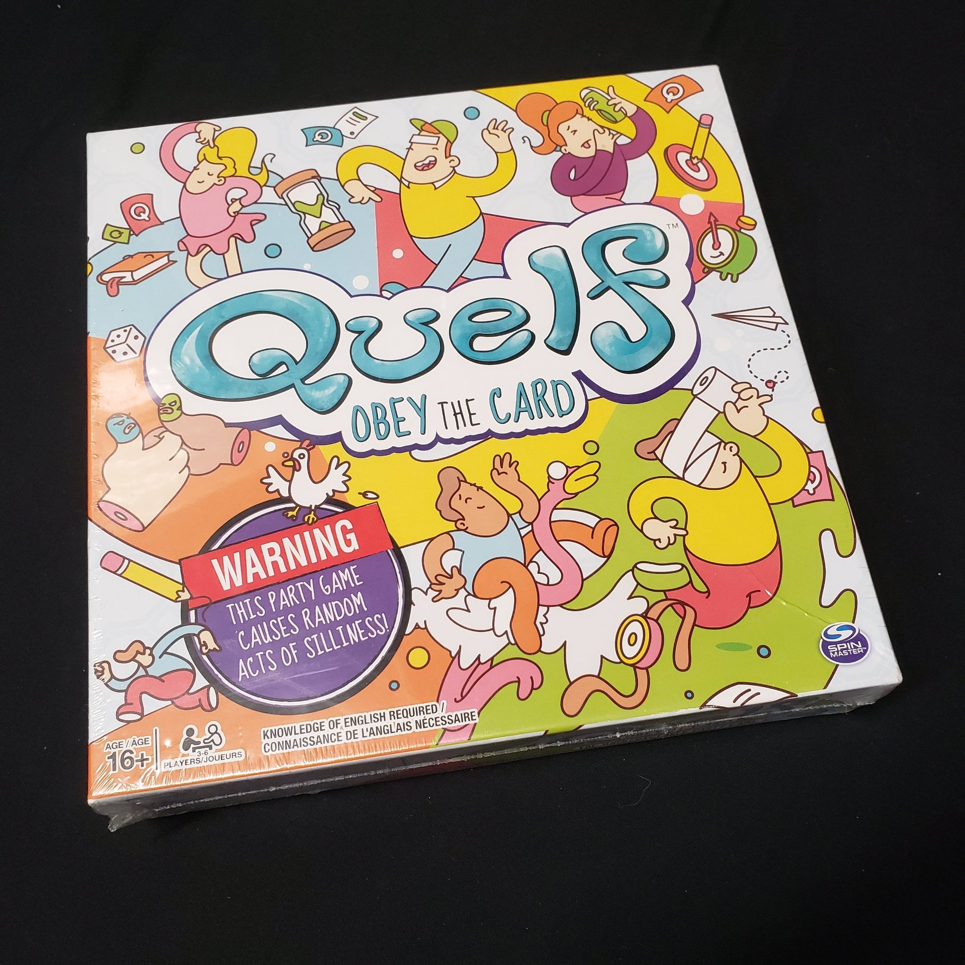 Image shows the front cover of the box of the Quelf party game