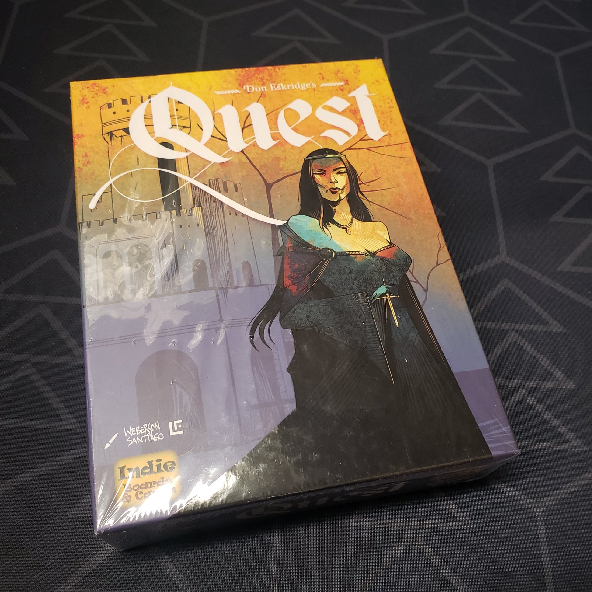 Image shows the front cover of the box of the Quest card game