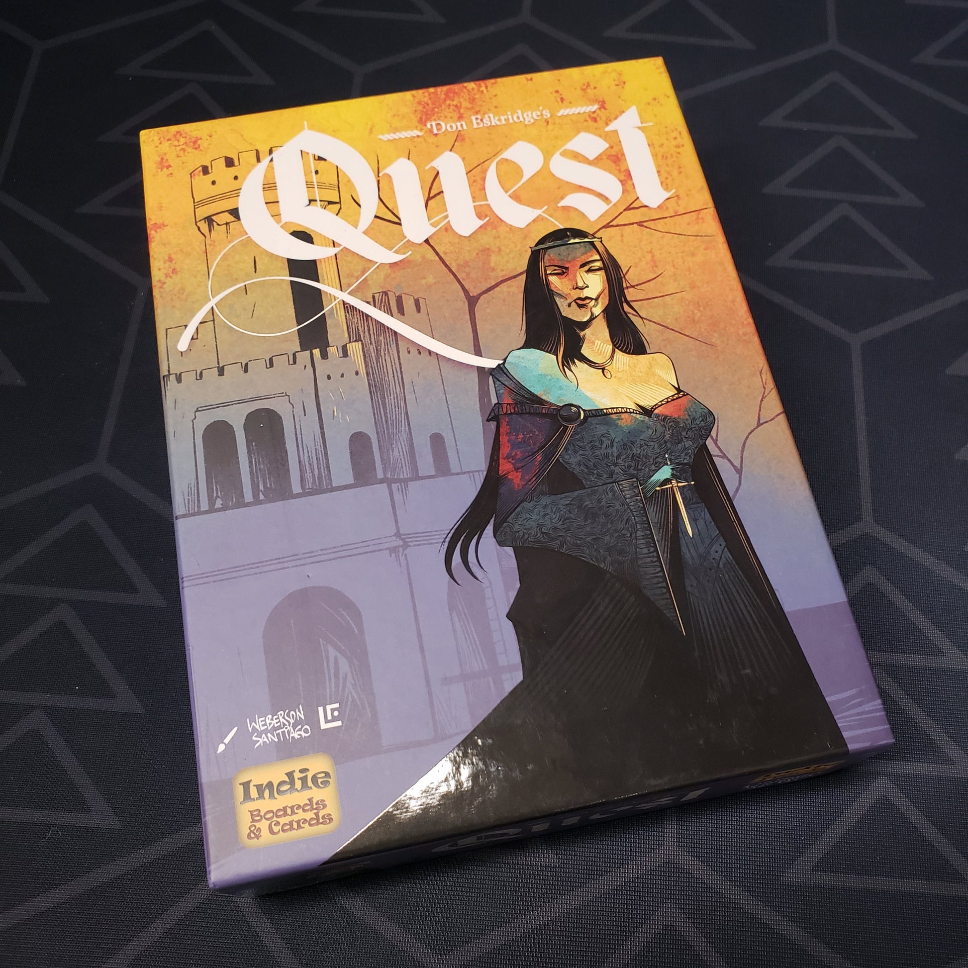 Image shows the front cover of the box of the Quest card game