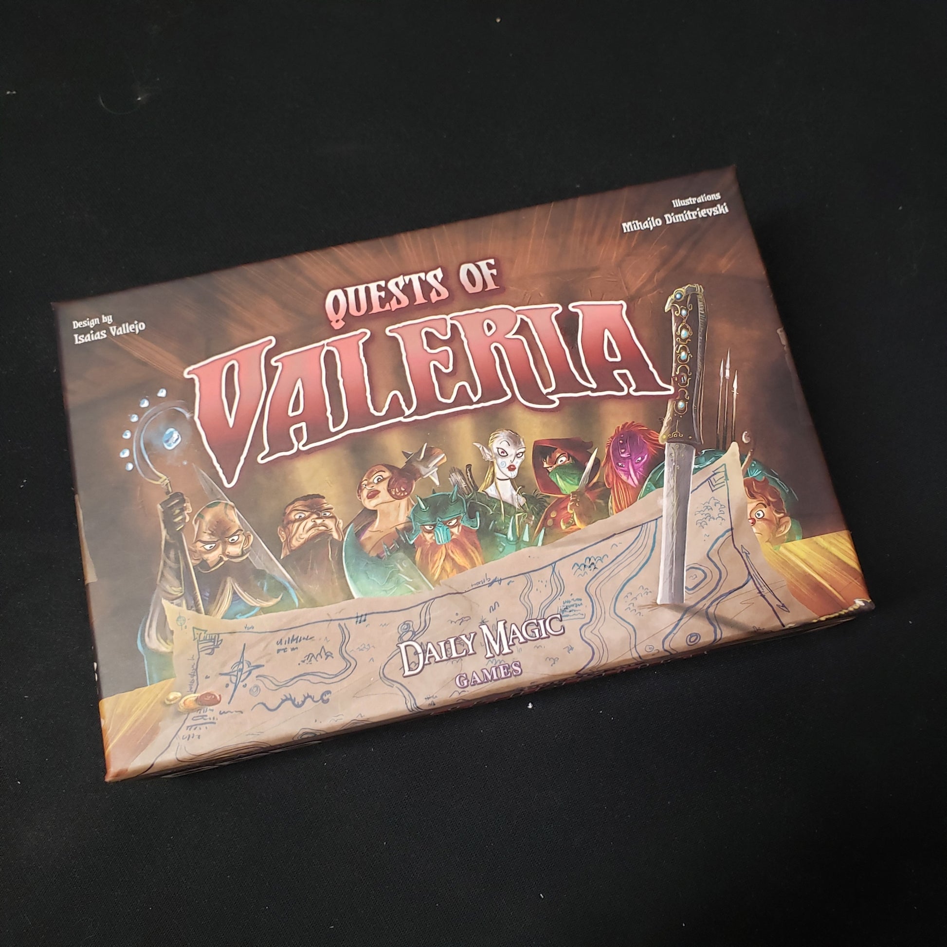 Image shows the front cover of the box of the Quests of Valeria card game