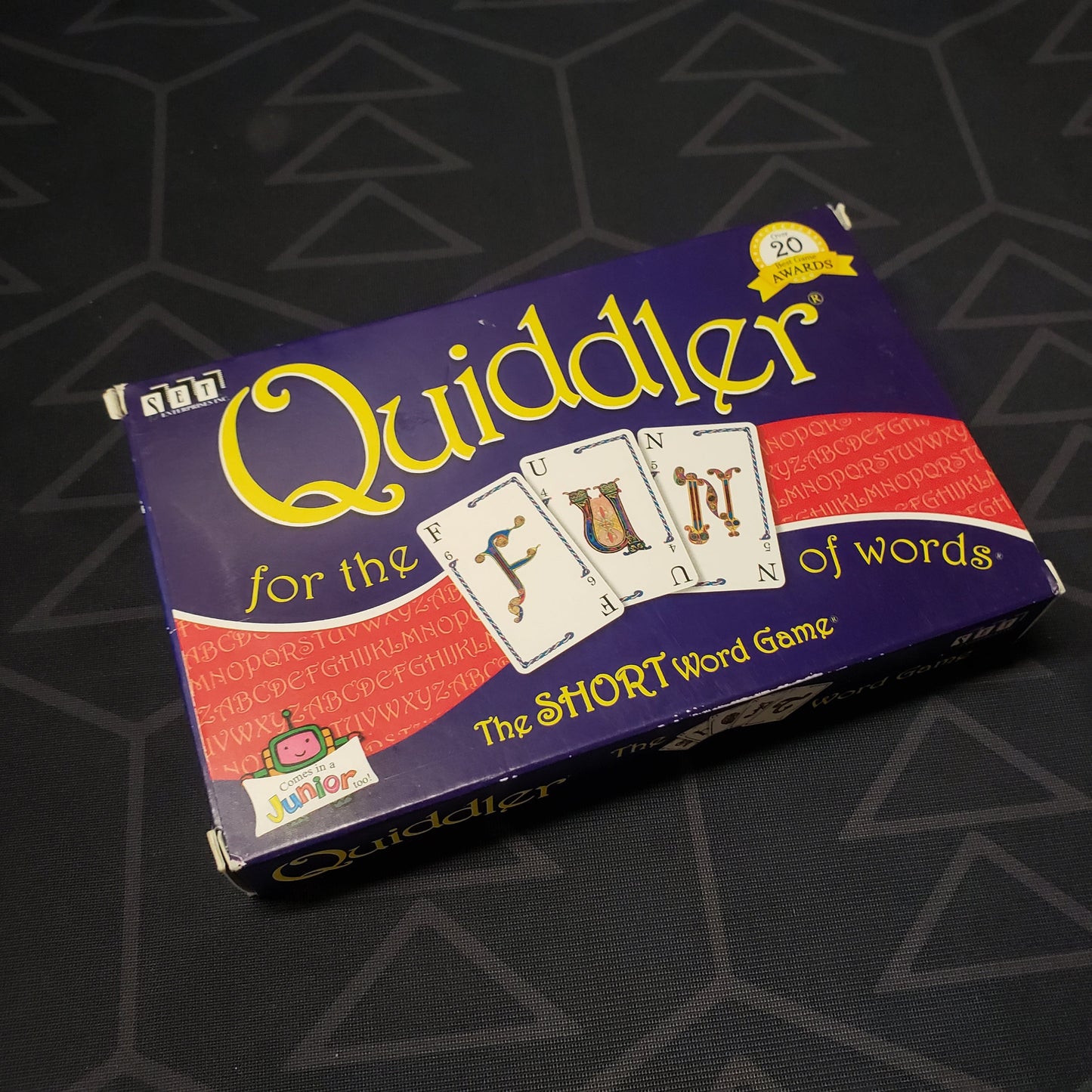 Image shows the front cover of the box of the Quiddler card game