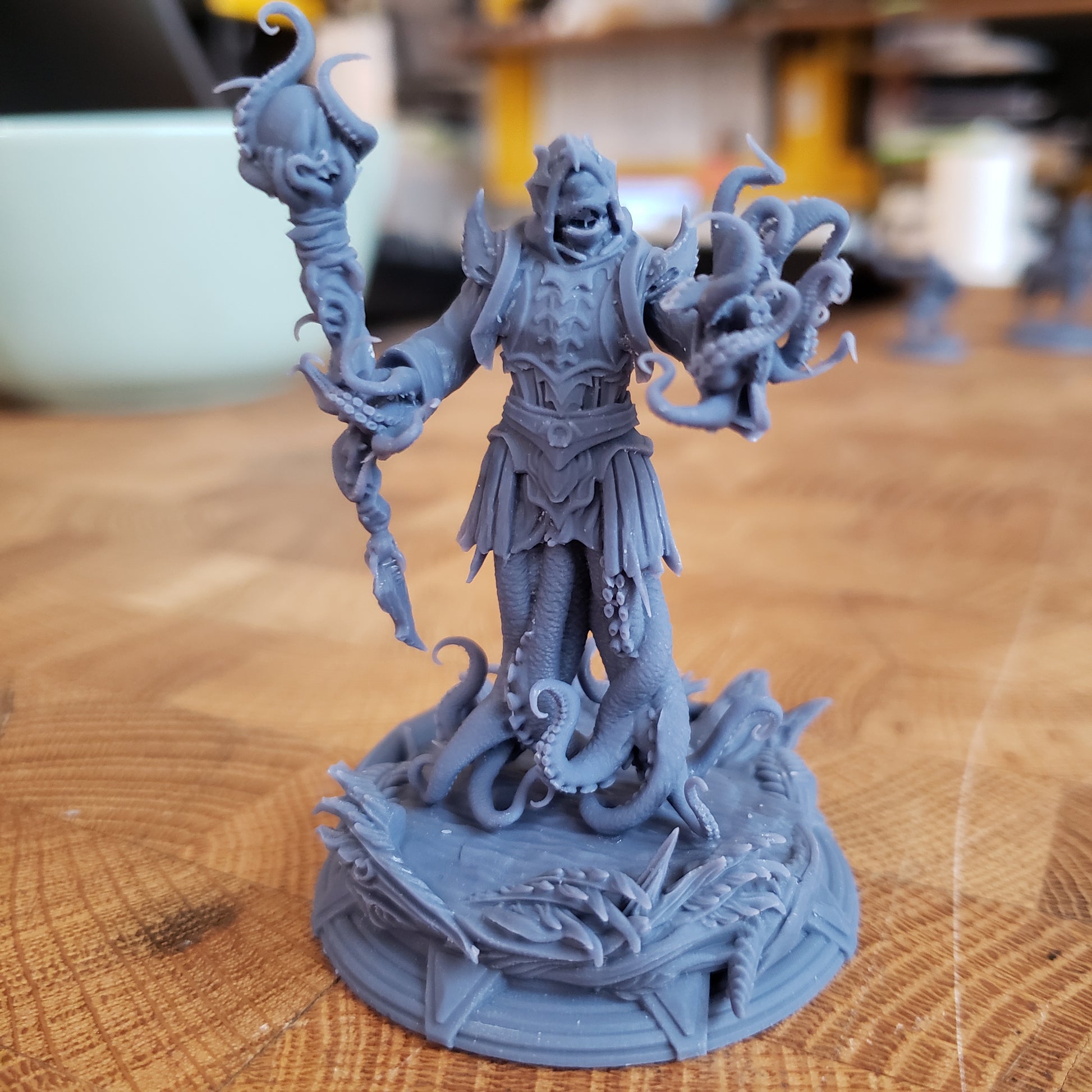 Image is a photo of a 3D printed royal squid horror gaming miniature printed in-house at All Systems Go
