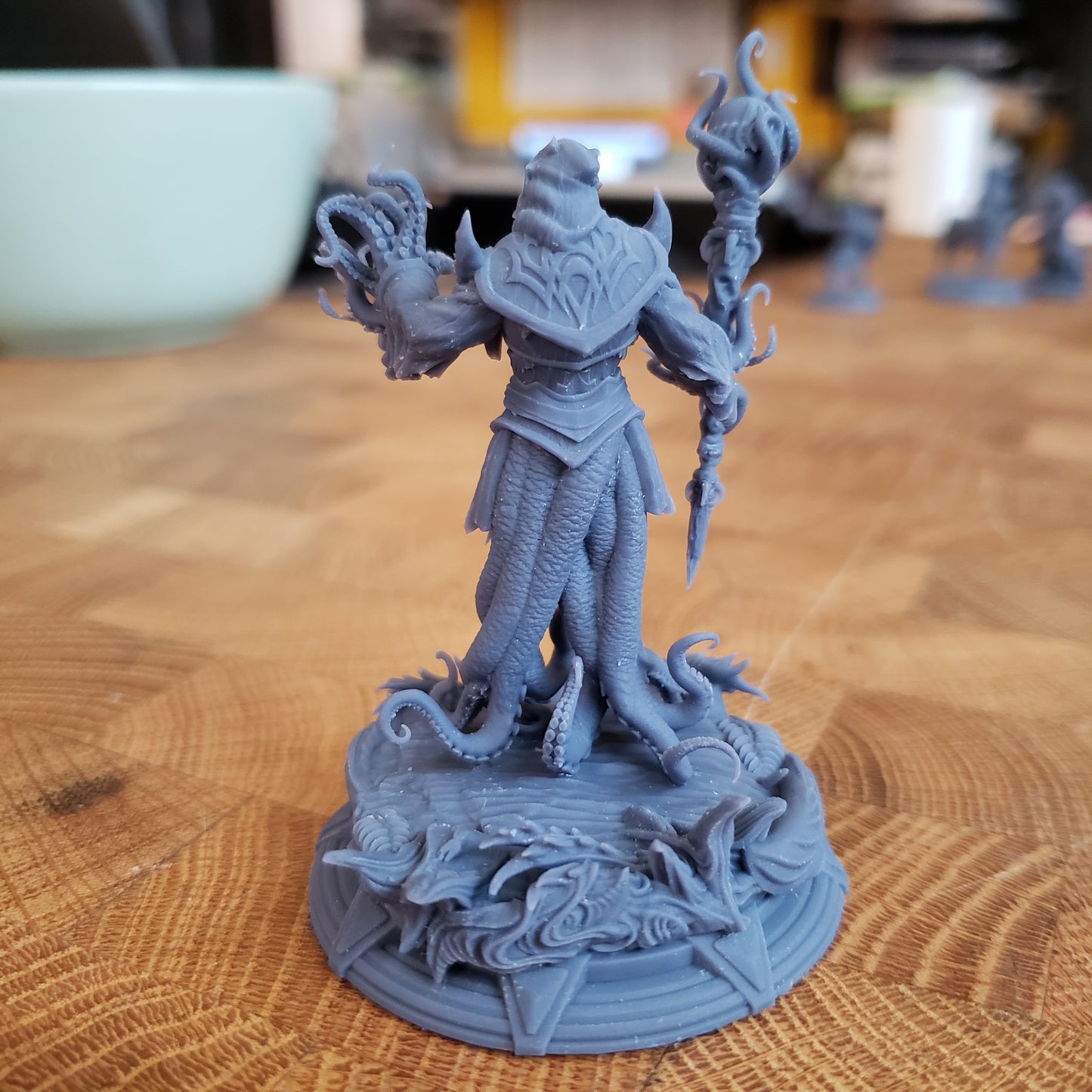 Image is a photo of a 3D printed royal squid horror gaming miniature printed in-house at All Systems Go