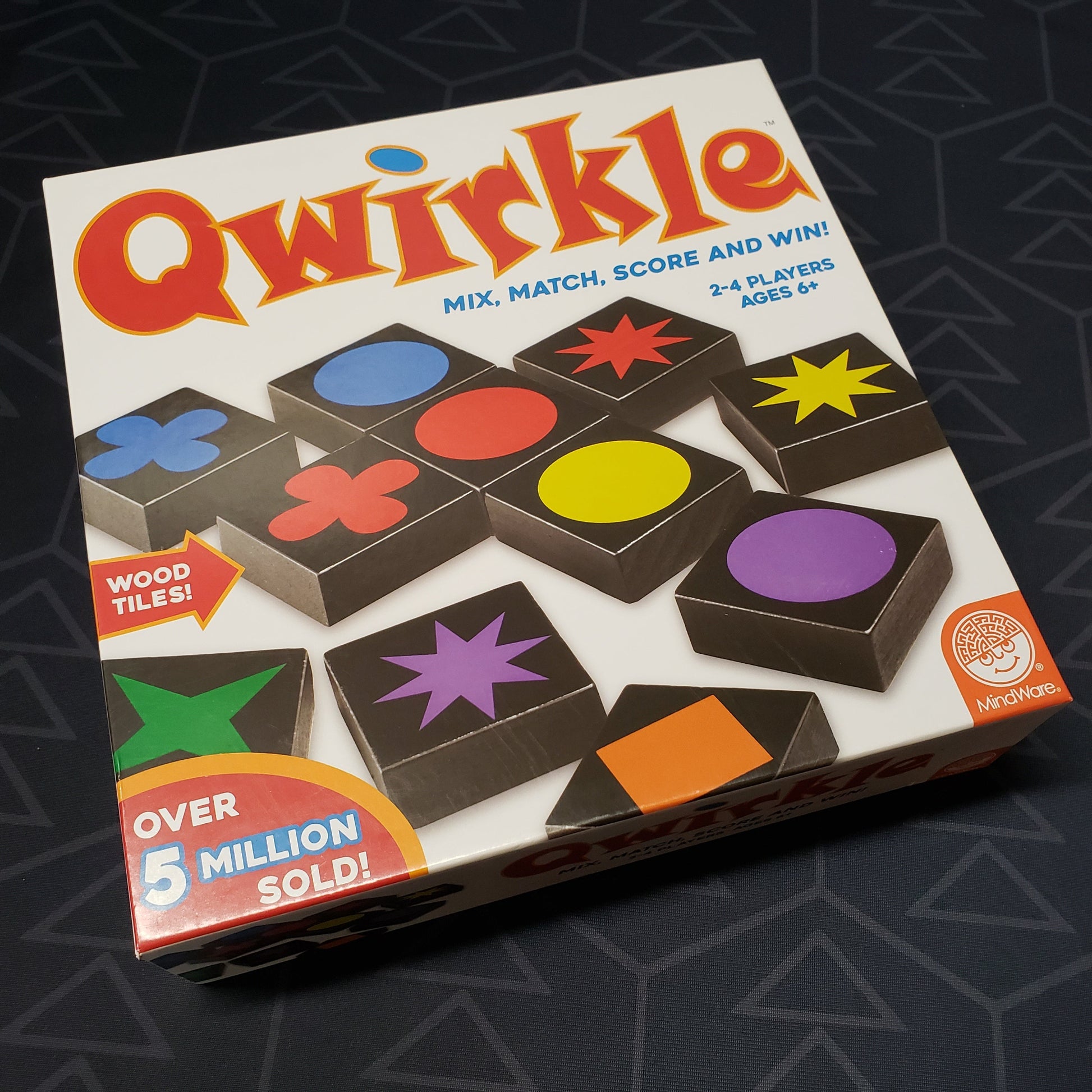 Image shows the front cover of the box for the Qwirkle board game