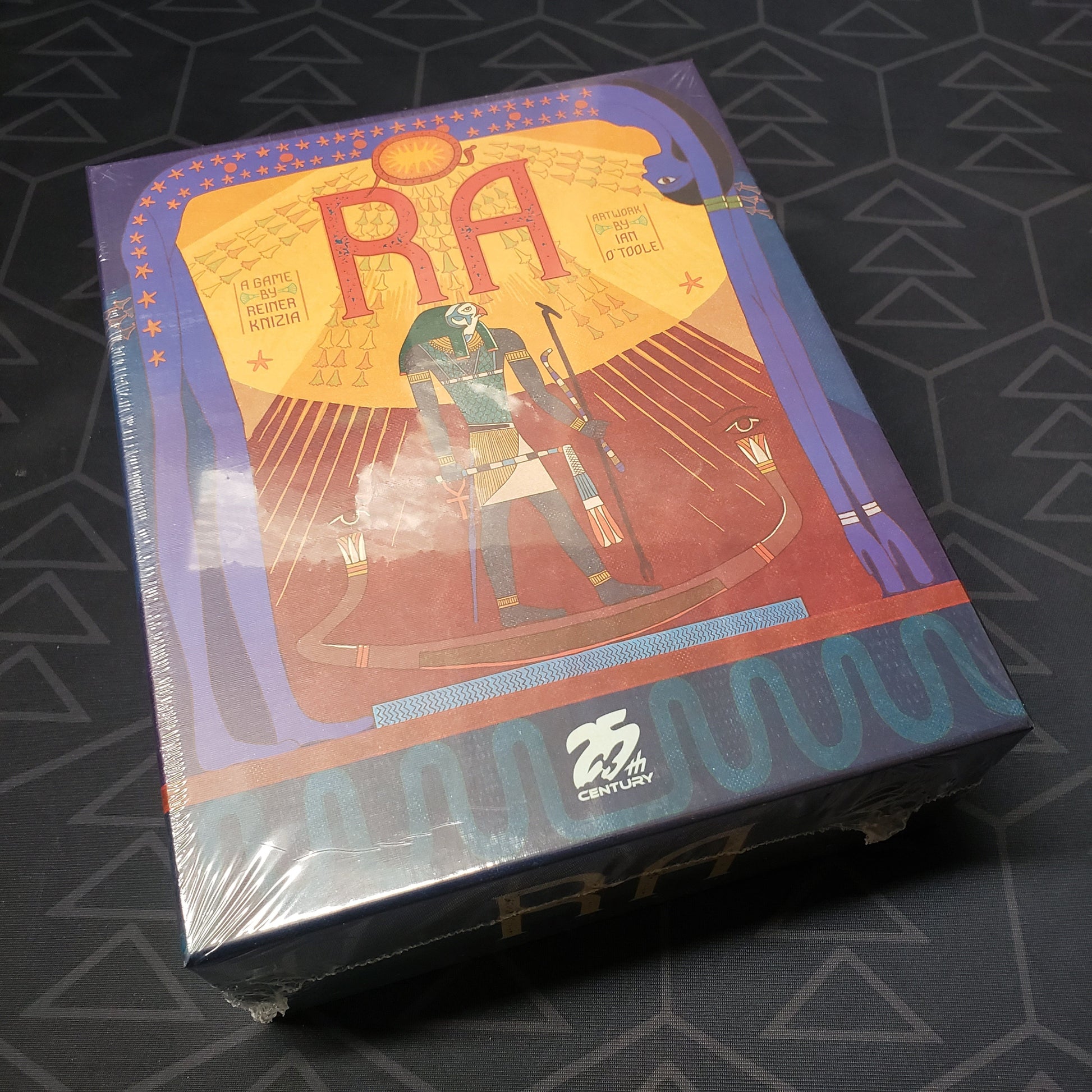Image shows the front cover of the box for the RA board game
