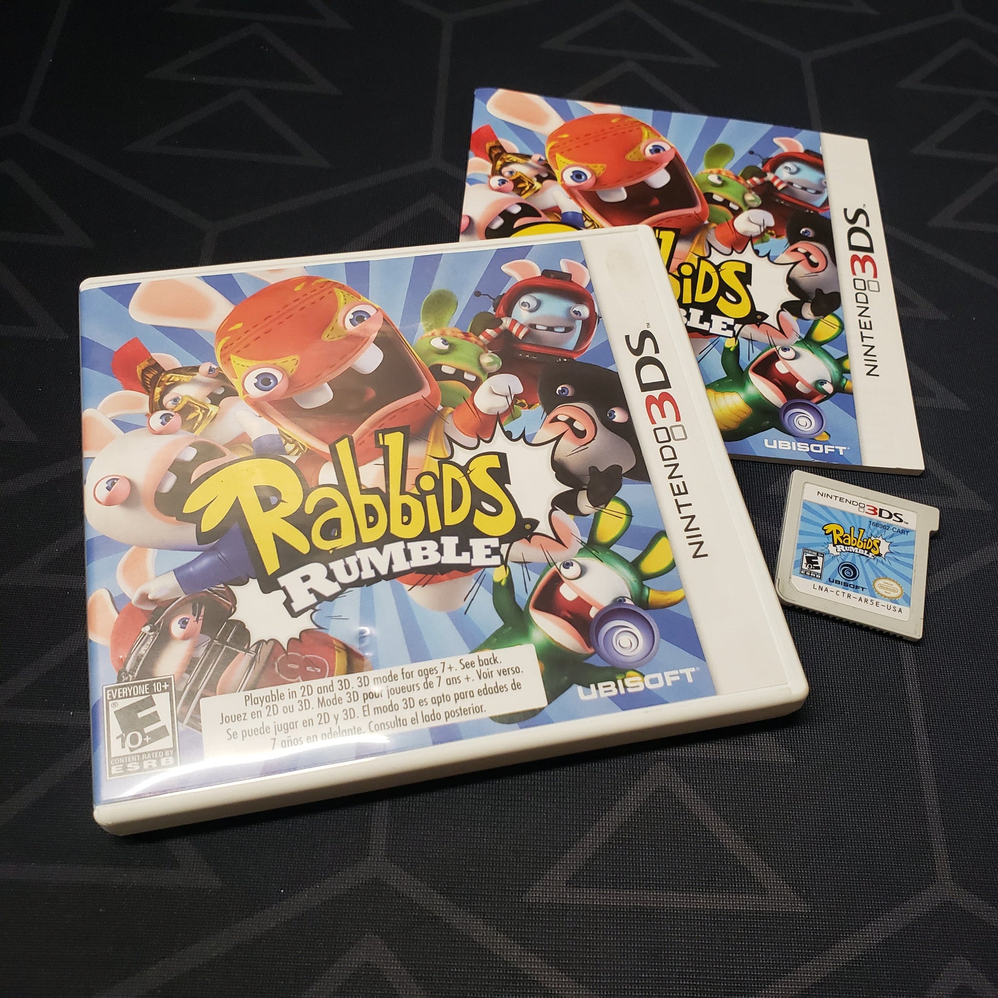 Image shows the case, manual and cartridge for the video game Rabbids Rumble for Nintendo 3DS