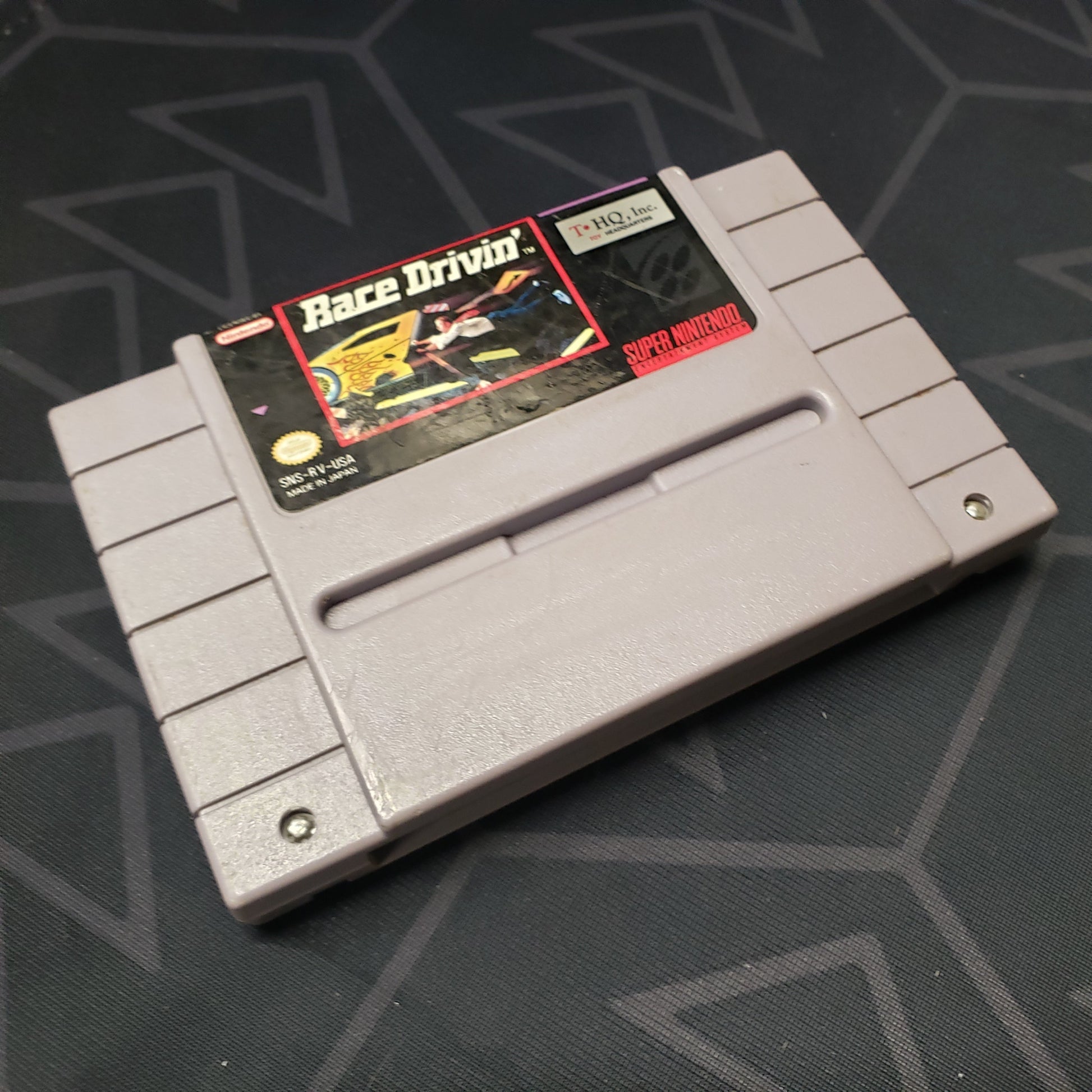 Image shows the front of the cartridge for the video game Race Drivin' for the Super Nintendo
