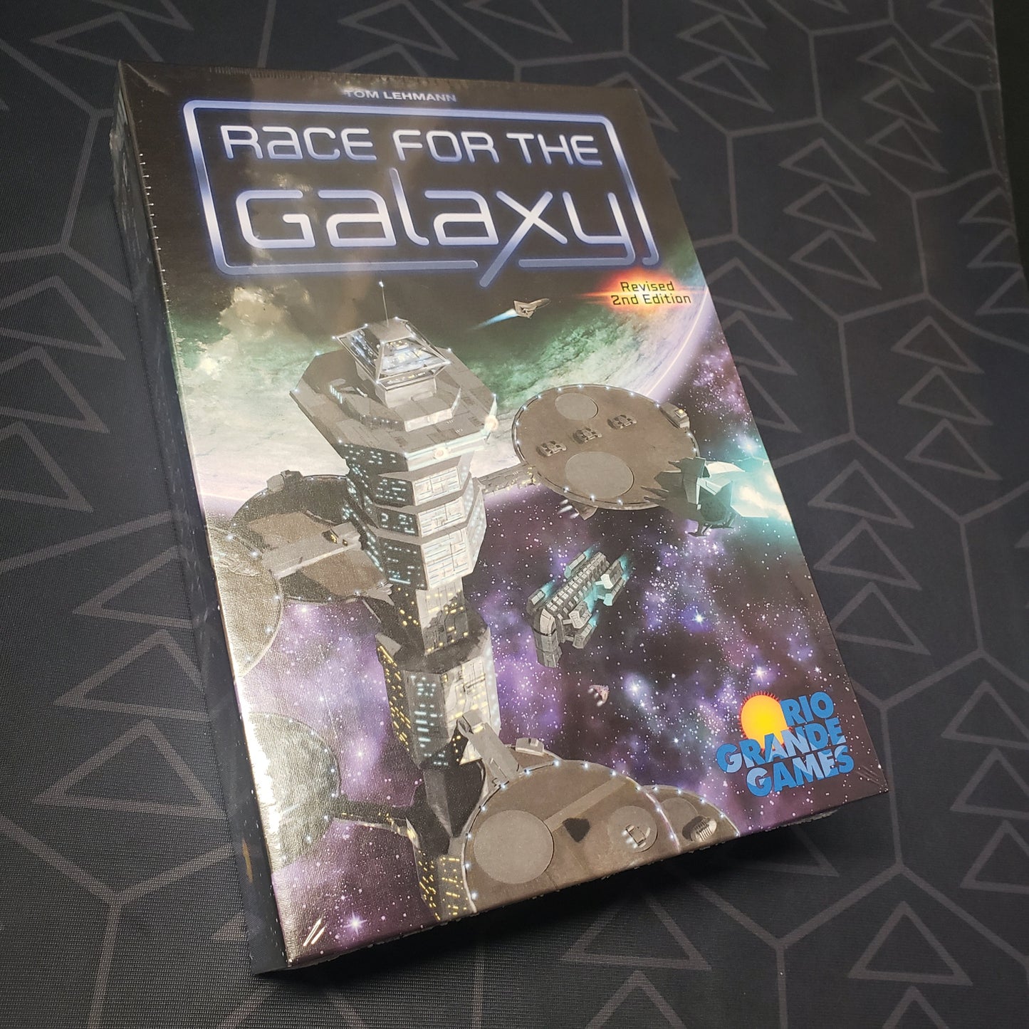 Image shows the front cover of the box for the Race for the Galaxy (Revised Second Edition) board game