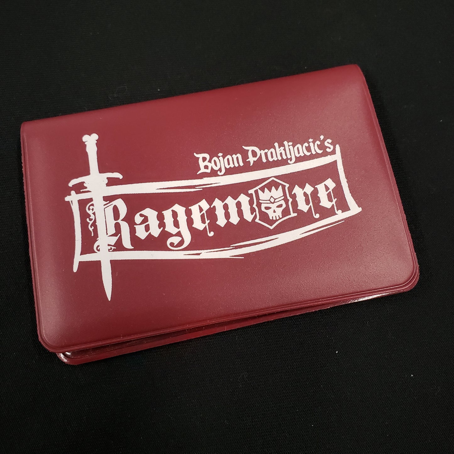 Image shows the front cover of the box of the Ragemore card game