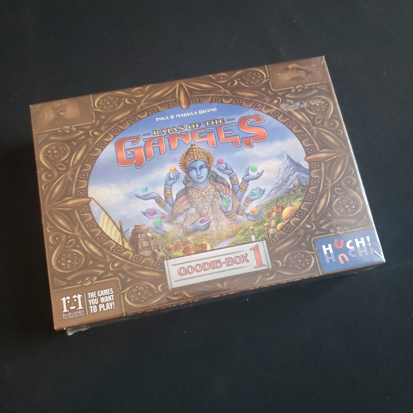 Image shows the front cover of the box of the Goodie Box 1 expansion for the board game Rajas of the Ganges