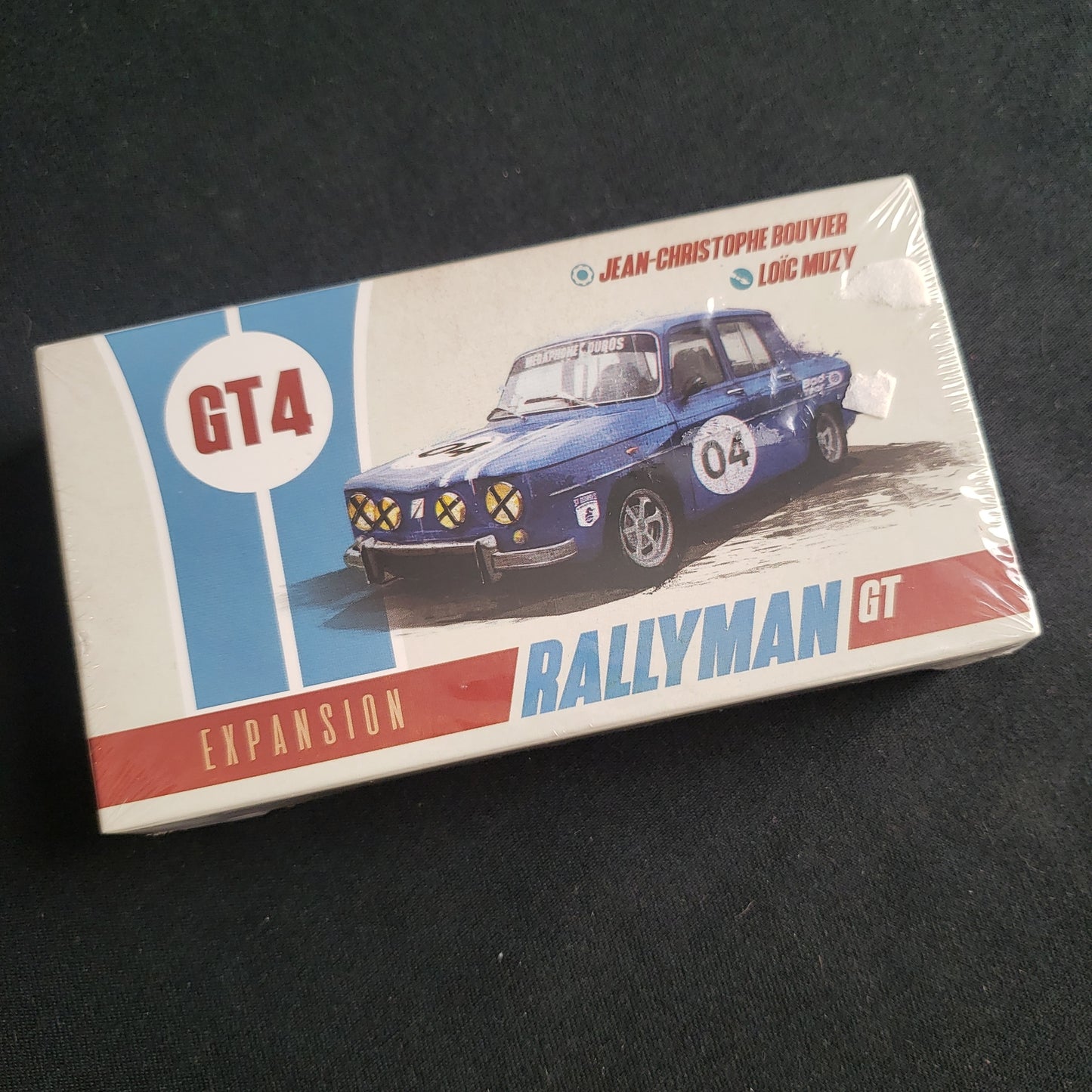 Image shows the front cover of the box of the GT4 expansion for the board game Rallyman: GT
