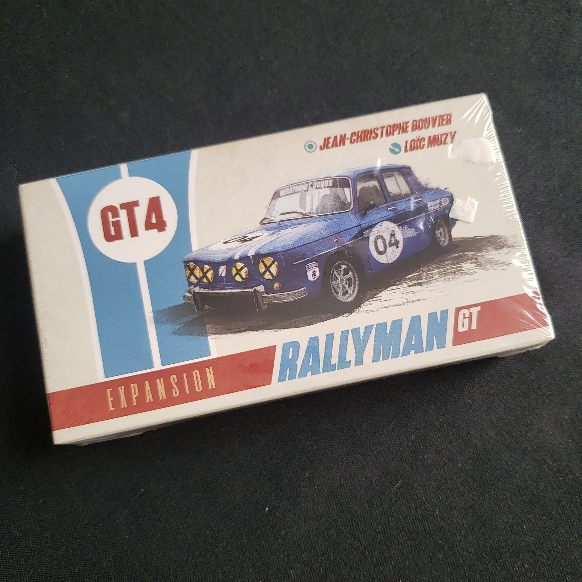 Image shows the front cover of the box of the GT4 expansion for the board game Rallyman: GT