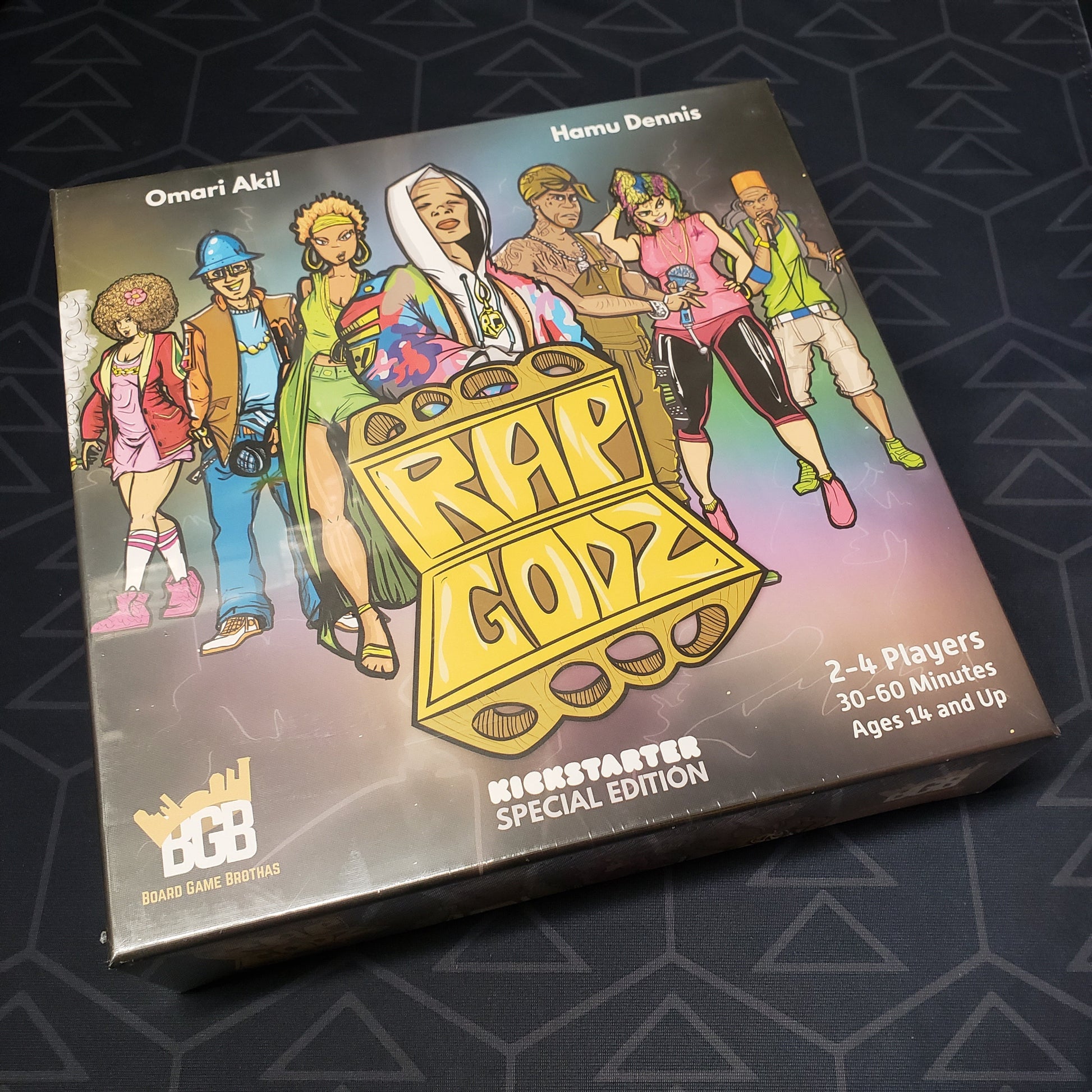 Image shows the front cover of the box for the board game Rap Godz (Kickstarter Special Edition)