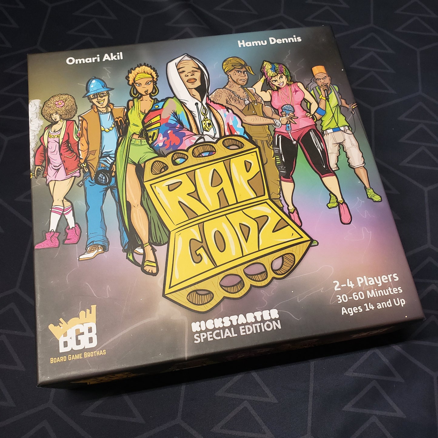 Image shows the front cover of the box for the board game Rap Godz (Kickstarter Special Edition)