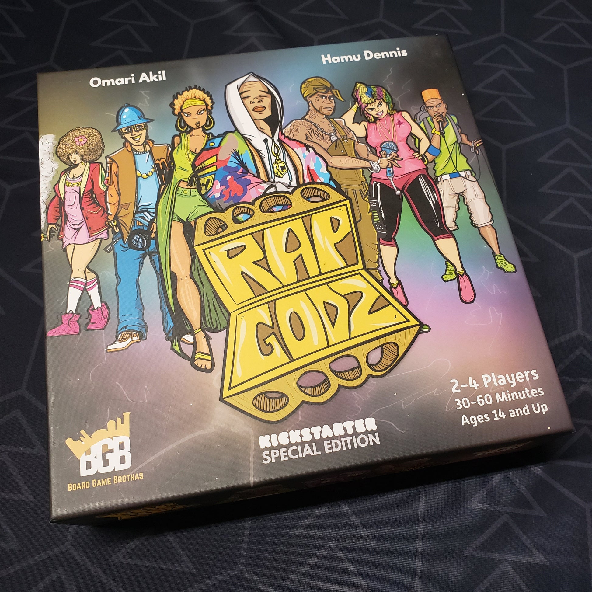 Image shows the front cover of the box for the board game Rap Godz (Kickstarter Special Edition)