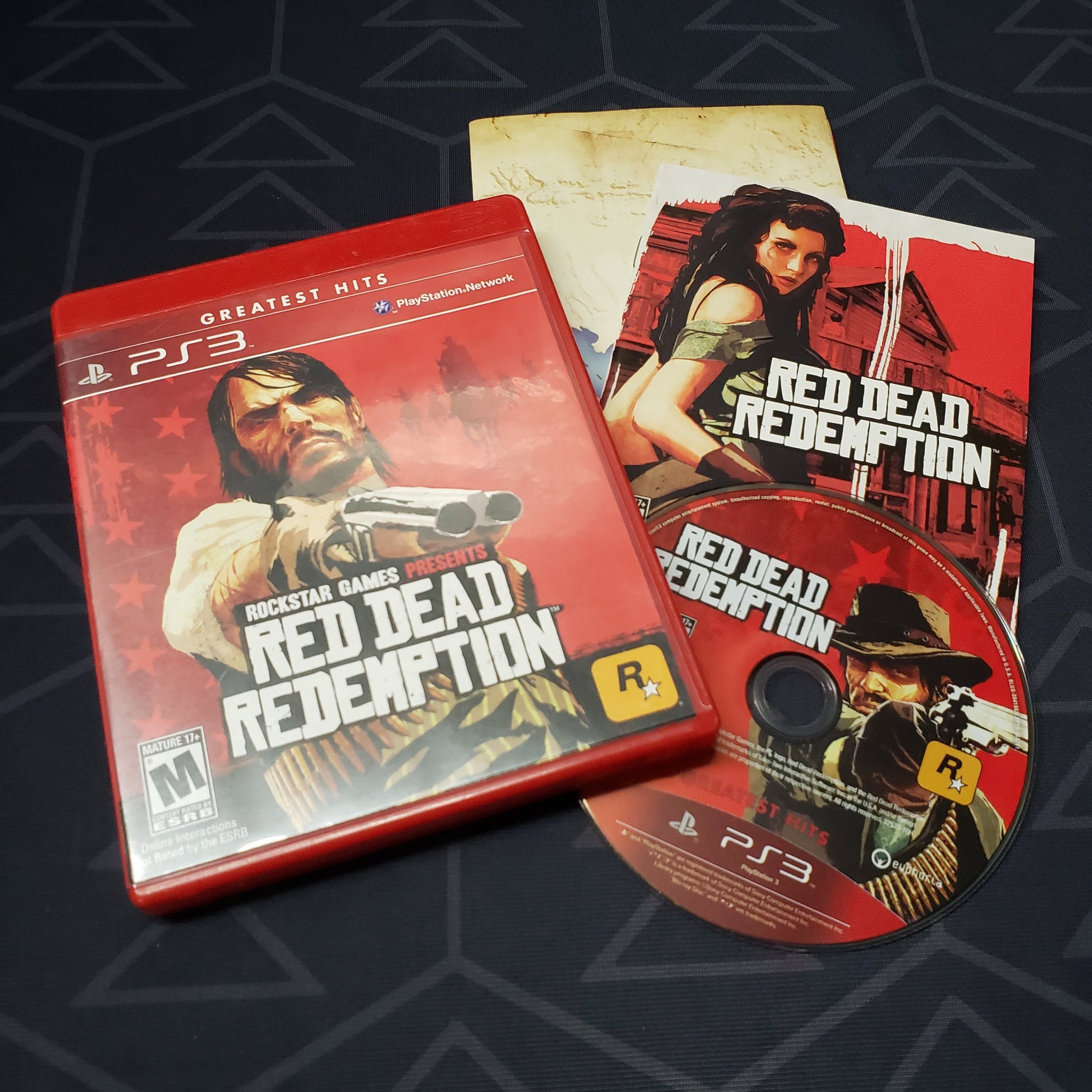 Image shows the case, manual, map and disc for the video game Red Dead Redemption for Playstation 3