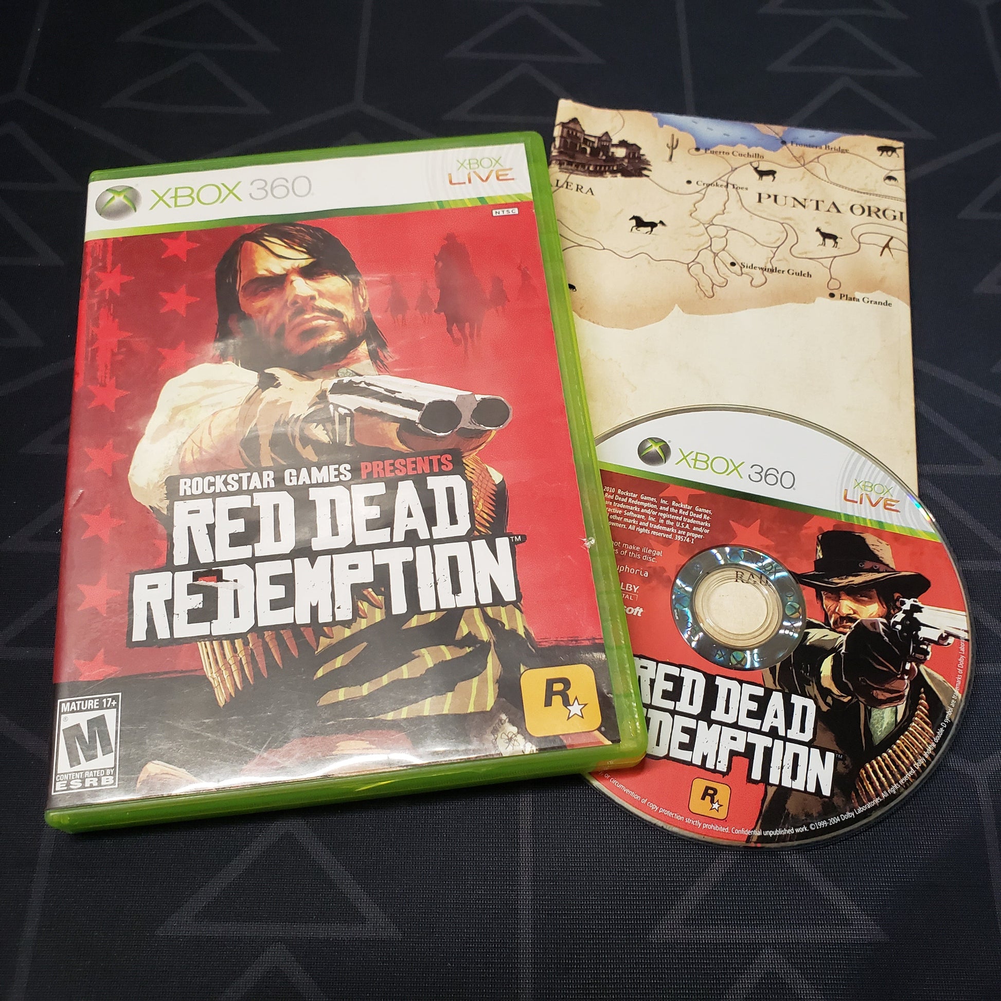 Image shows the case, map and disc for the video game Red Dead Redemption for Xbox 360