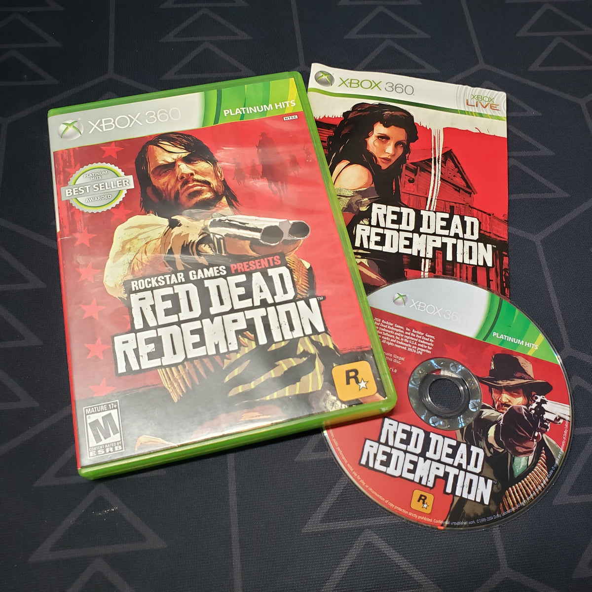 Image shows the case, manual and disc for the video game Red Dead Redemption for Xbox 360
