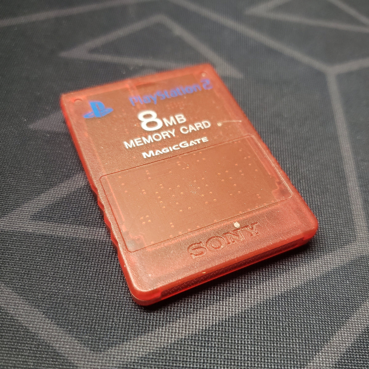 Image shows the front of a red Sony 8MB Memory Card for the Playstation 2 video game system