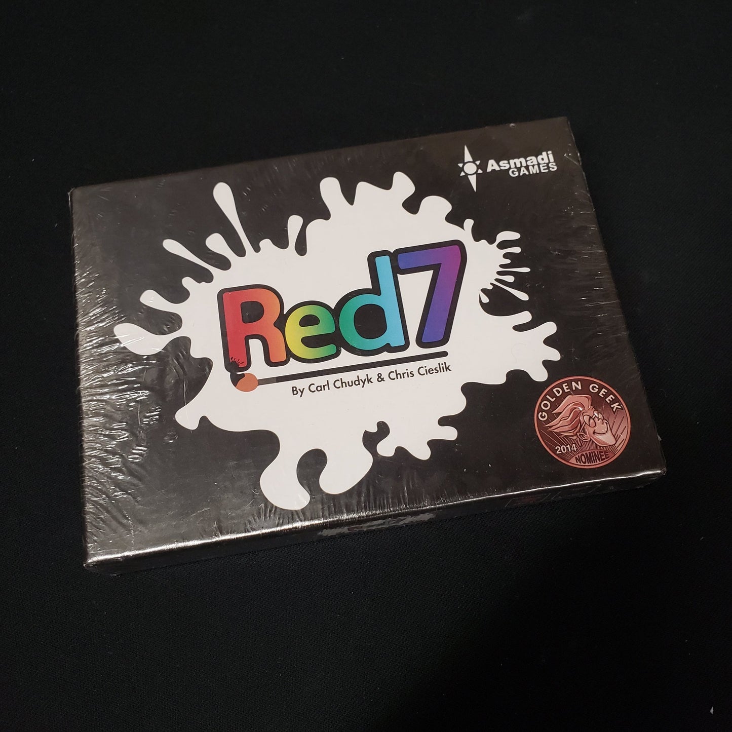 Image shows the front cover of the box of the card game Red7