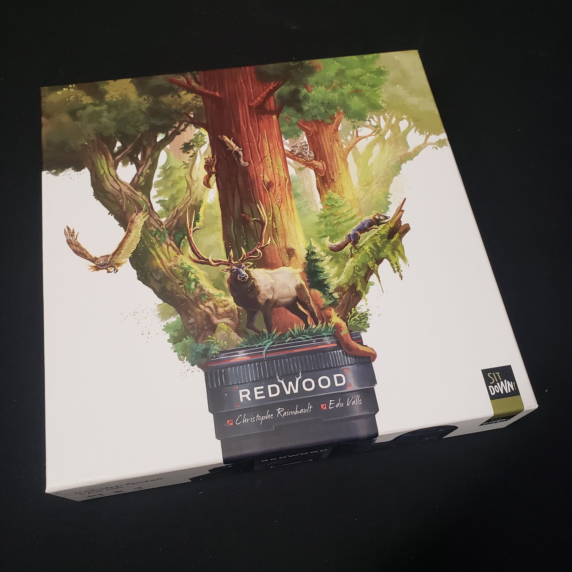 Image shows the front cover of the box of the Redwood board game