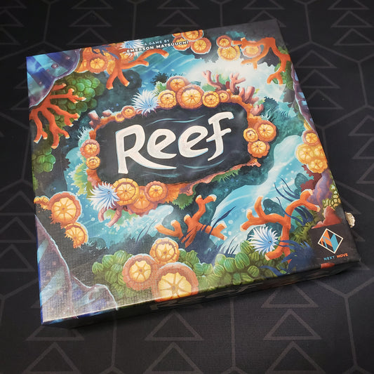 Image shows the front cover of the box of the Reef board game