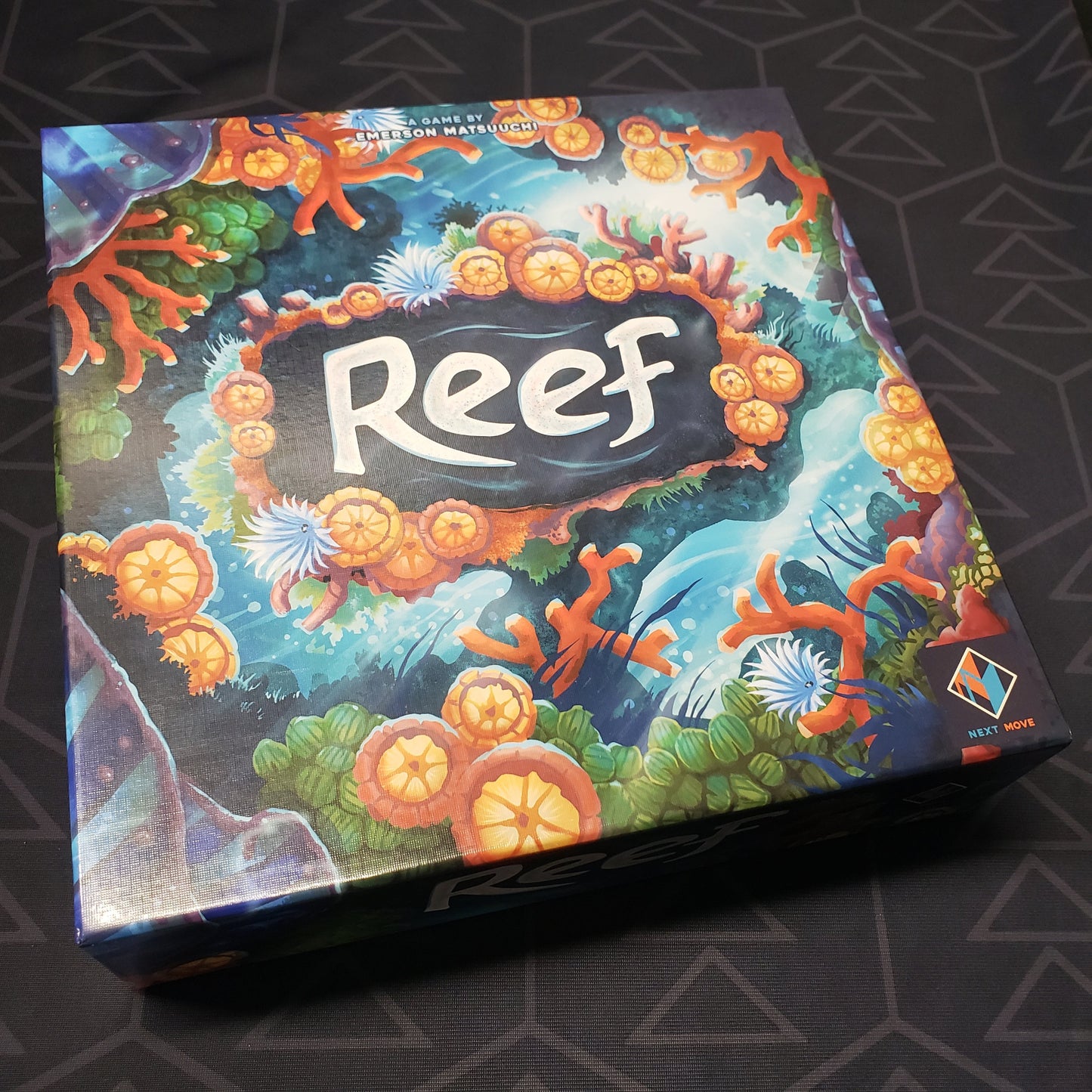Image shows the front cover of the box of the Reef board game